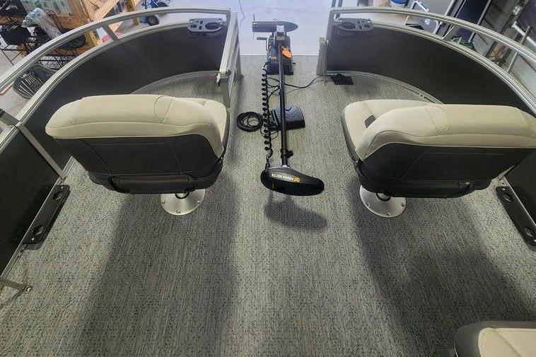 2026 Sun Tracker Bass Buggy 16 DLX interior with two swivel seats and trolling motor.