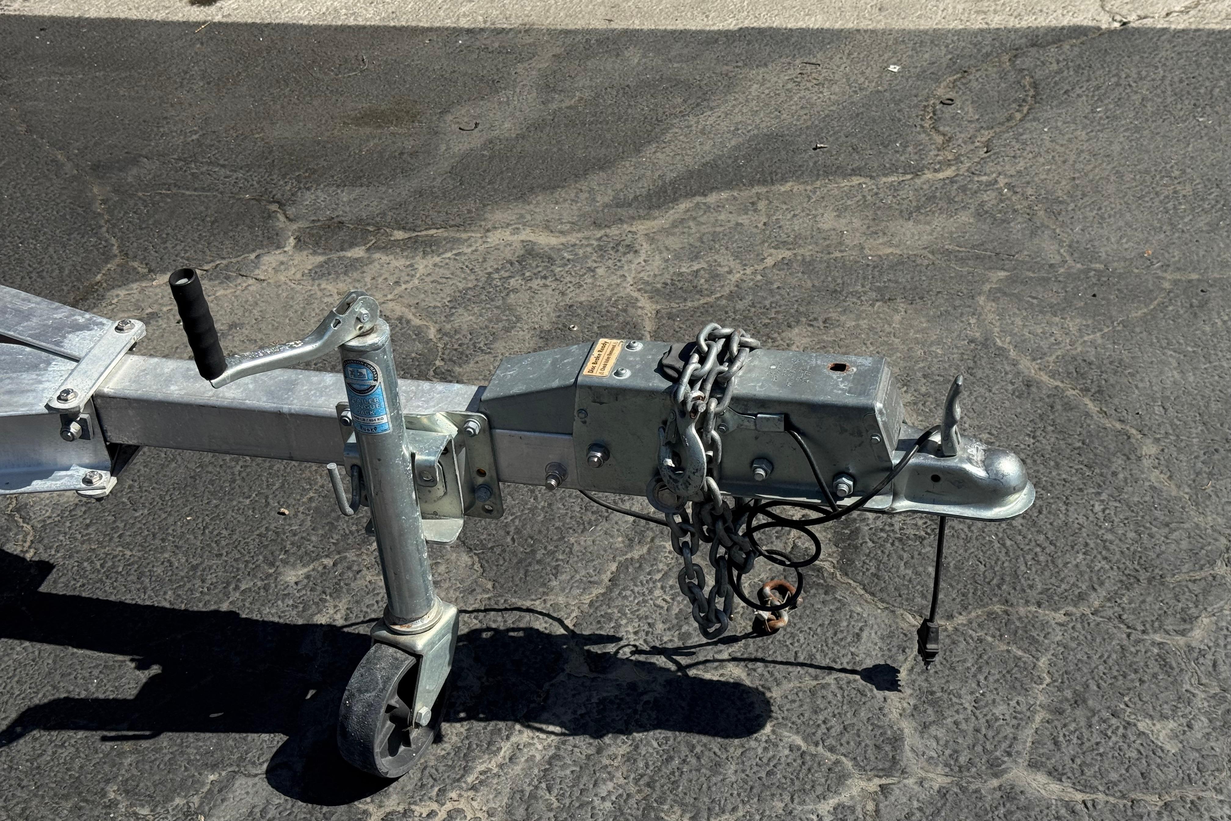 Trailer hitch of a 2020 NauticStar 203 SC boat on asphalt surface.