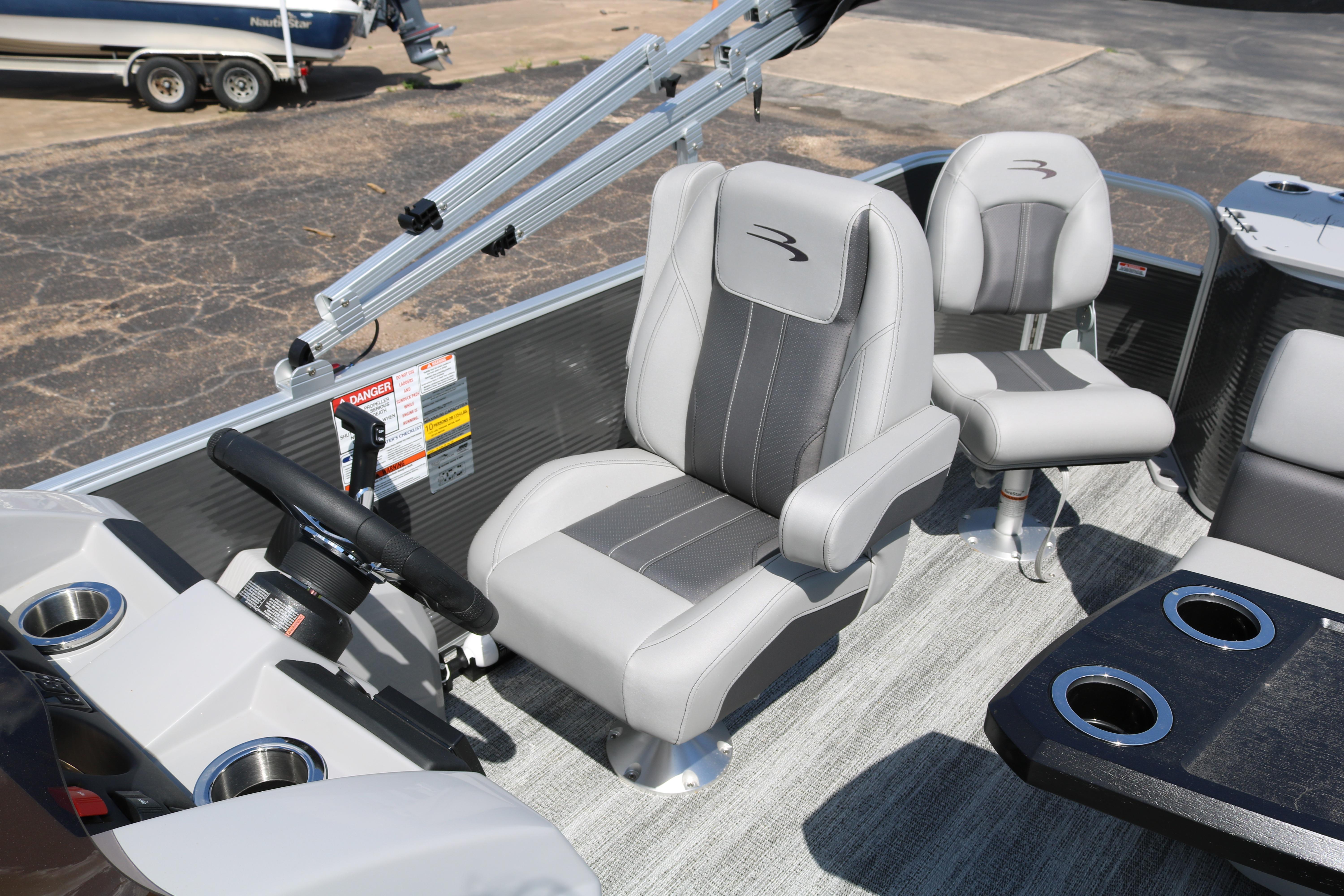 2026 Bennington 20SXSNP REAR FISH boat interior with gray seating and steering wheel.