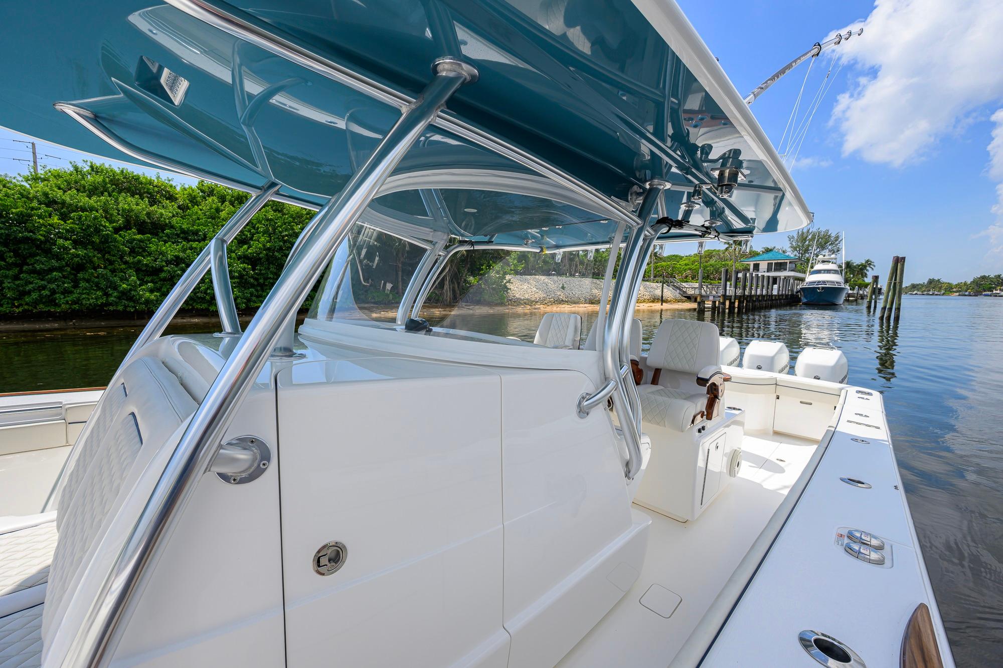 2020 Valhalla Boatworks V-41, sleek design, docked by lush greenery and calm waters.