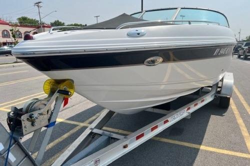 2006 Chaparral 220 SSi boat on trailer, parked in a lot, ready for transport.