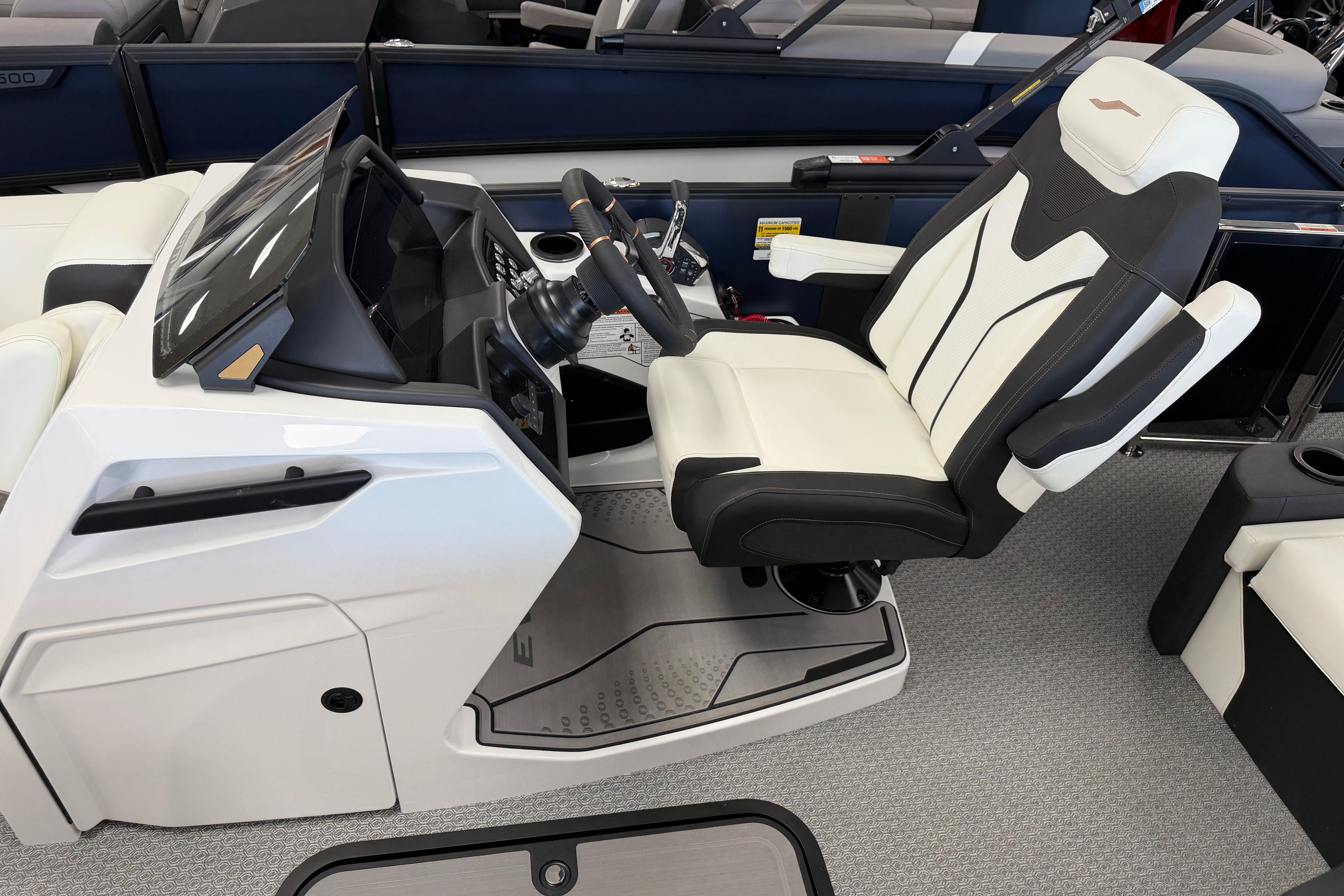 2026 Evotti 721CS boat interior with modern helm and luxurious captain's chair.