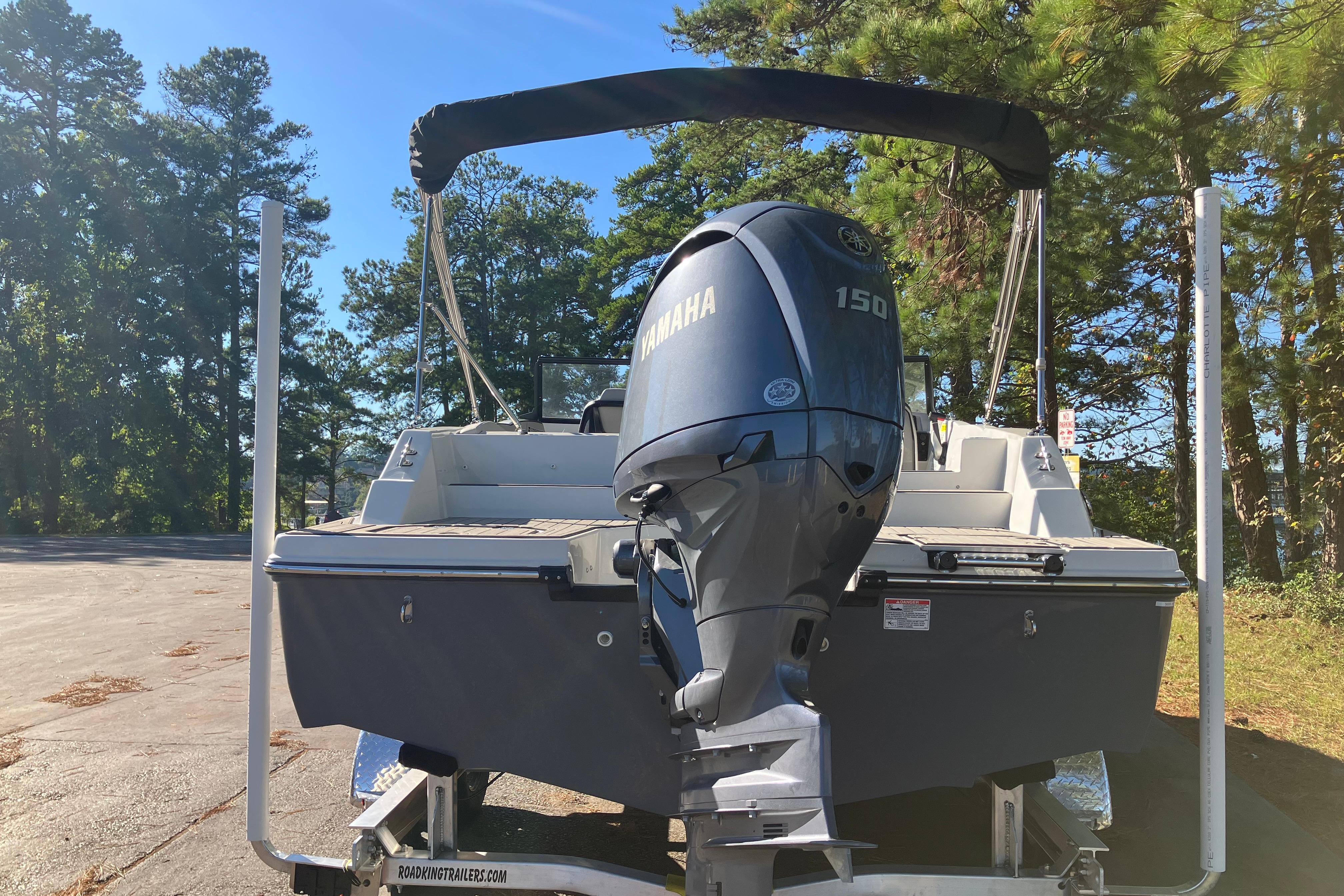 2025 Starcraft SVX 210 OB boat with Yamaha 150 engine, parked outdoors.