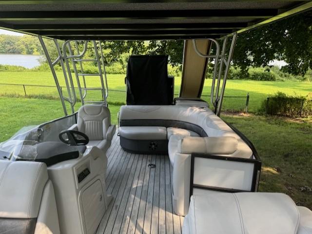 2017 Crest Caribbean 250 L pontoon boat with spacious seating and scenic outdoor view.