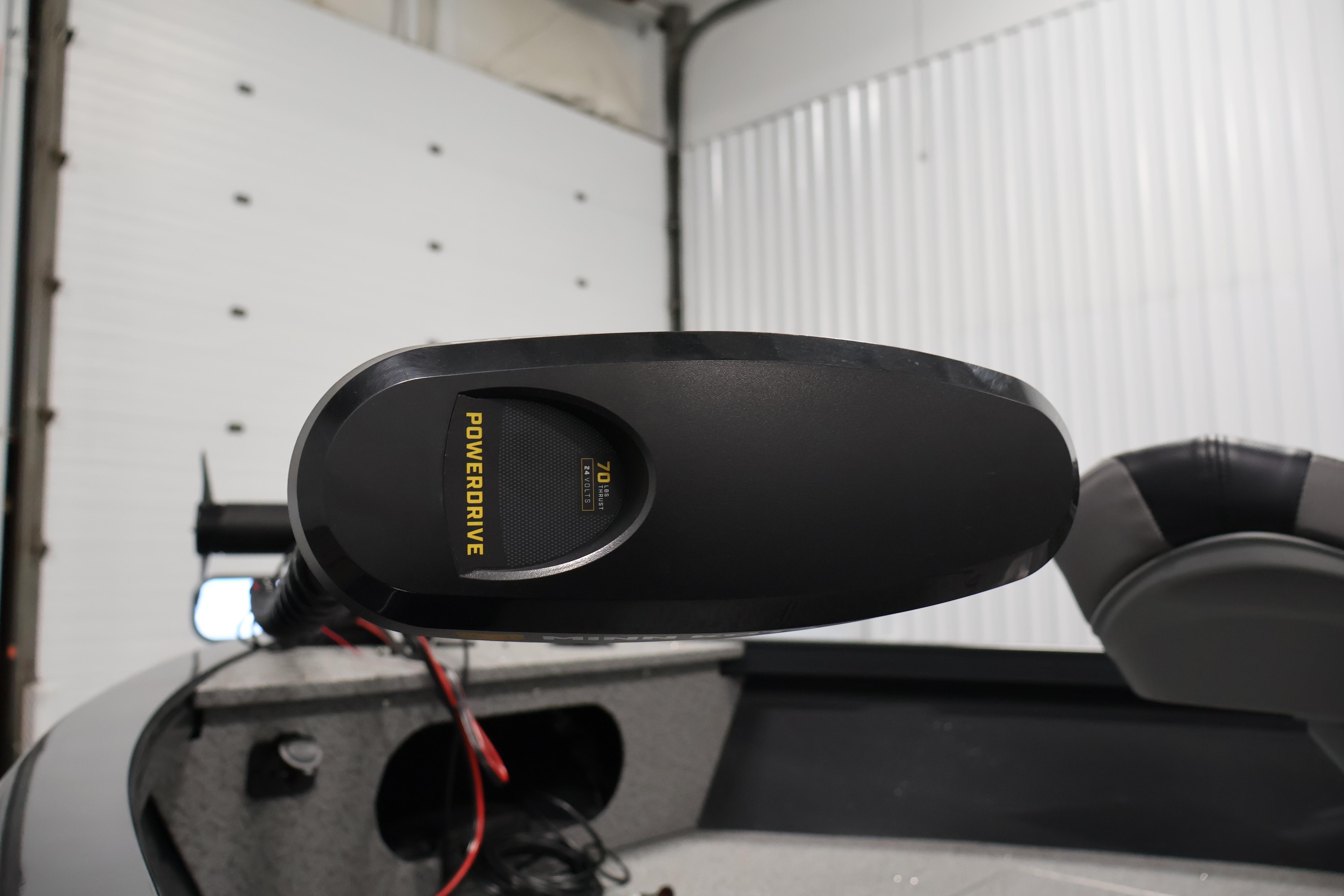 2026 Crestliner 1850 Kodiak SC boat with PowerDrive trolling motor in a garage.