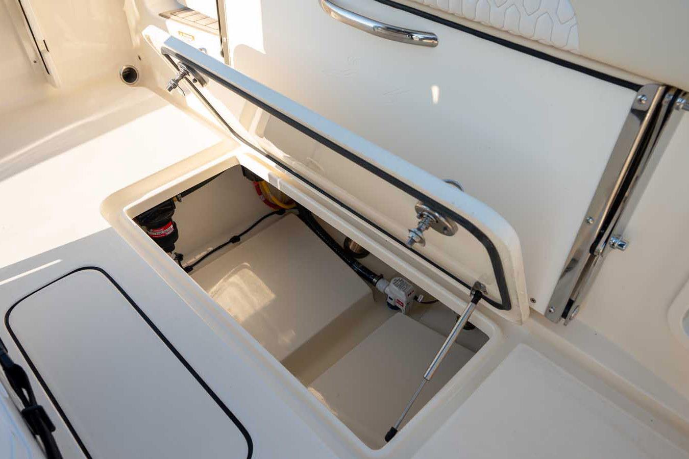 Manufacturer Provided Image: 2026 Scout 220 XSF boat storage compartment with open hatch, showcasing interior details.
