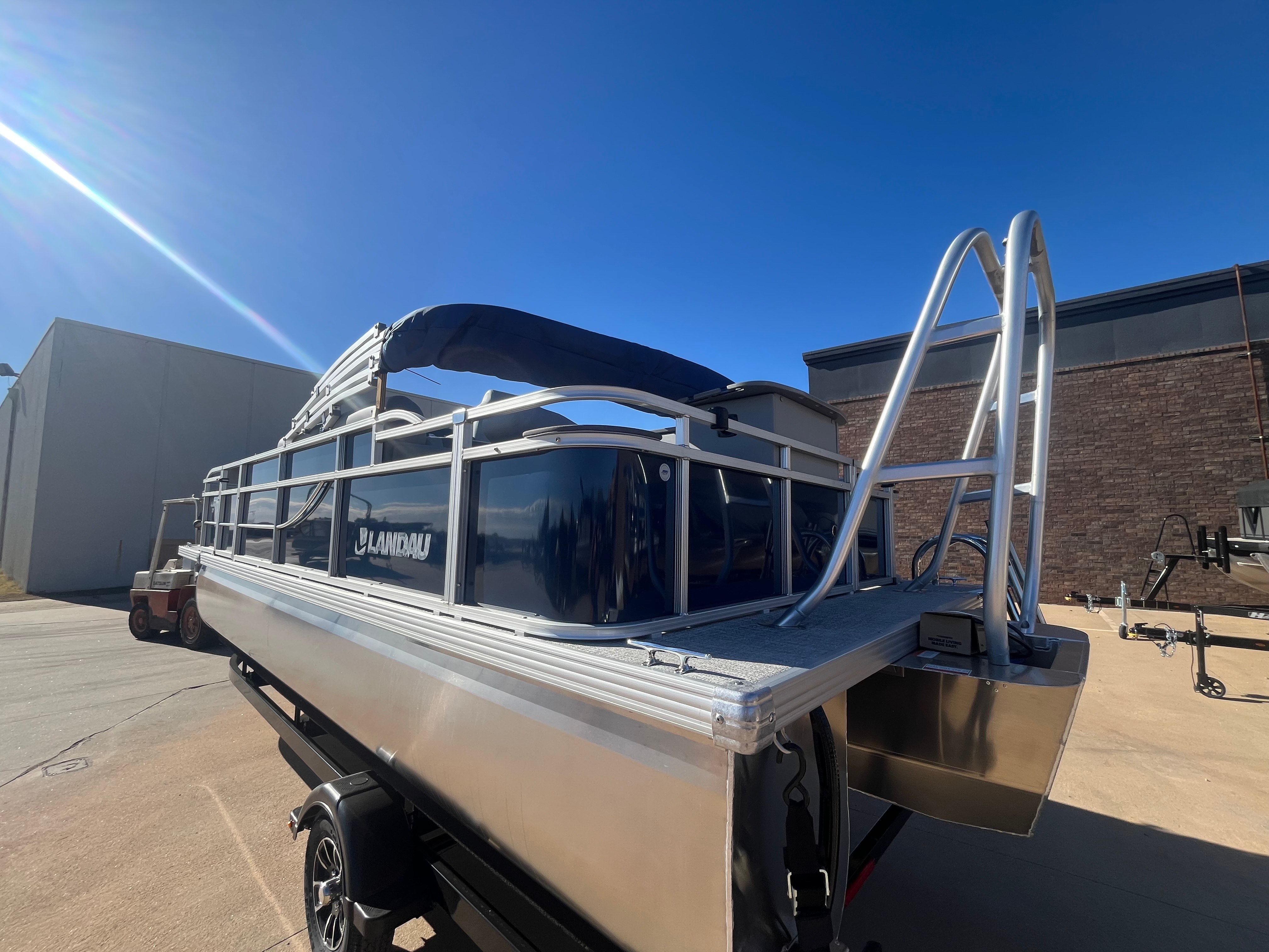 2026 Landau Alure 21CC Fish boat on trailer under sunny skies.