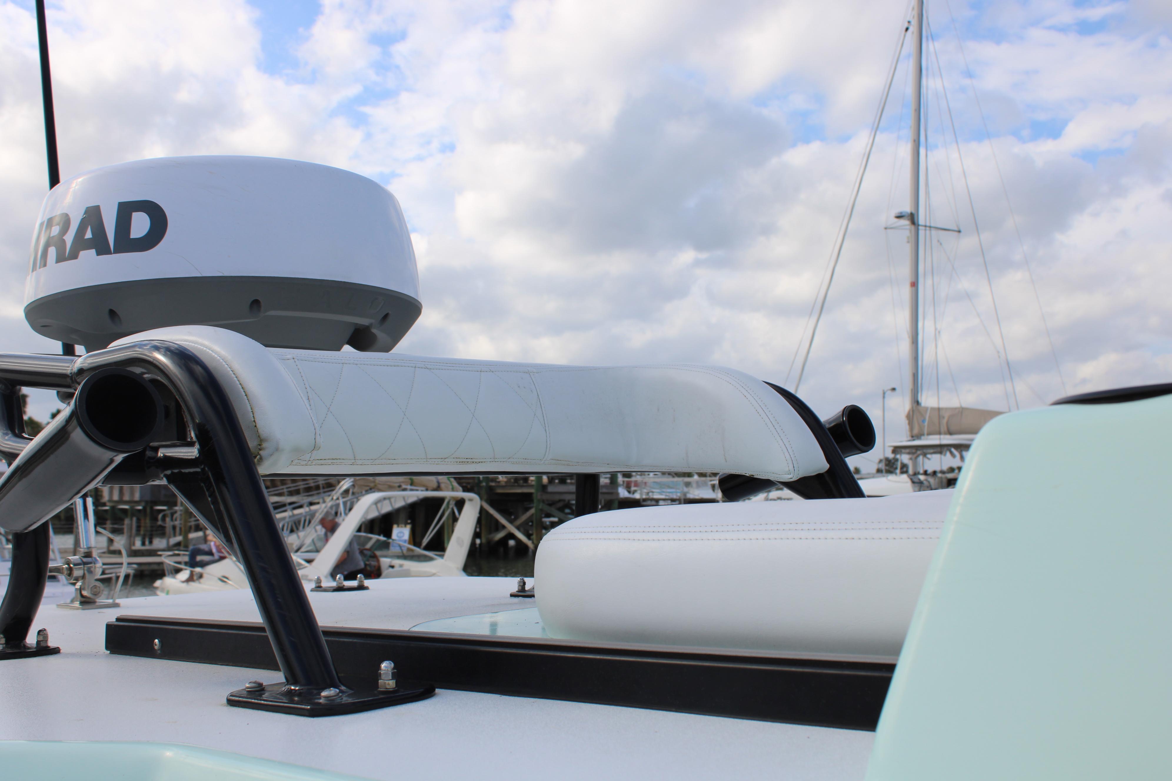 ZCB 26 Freemason 2021 boat with radar, docked under cloudy sky.