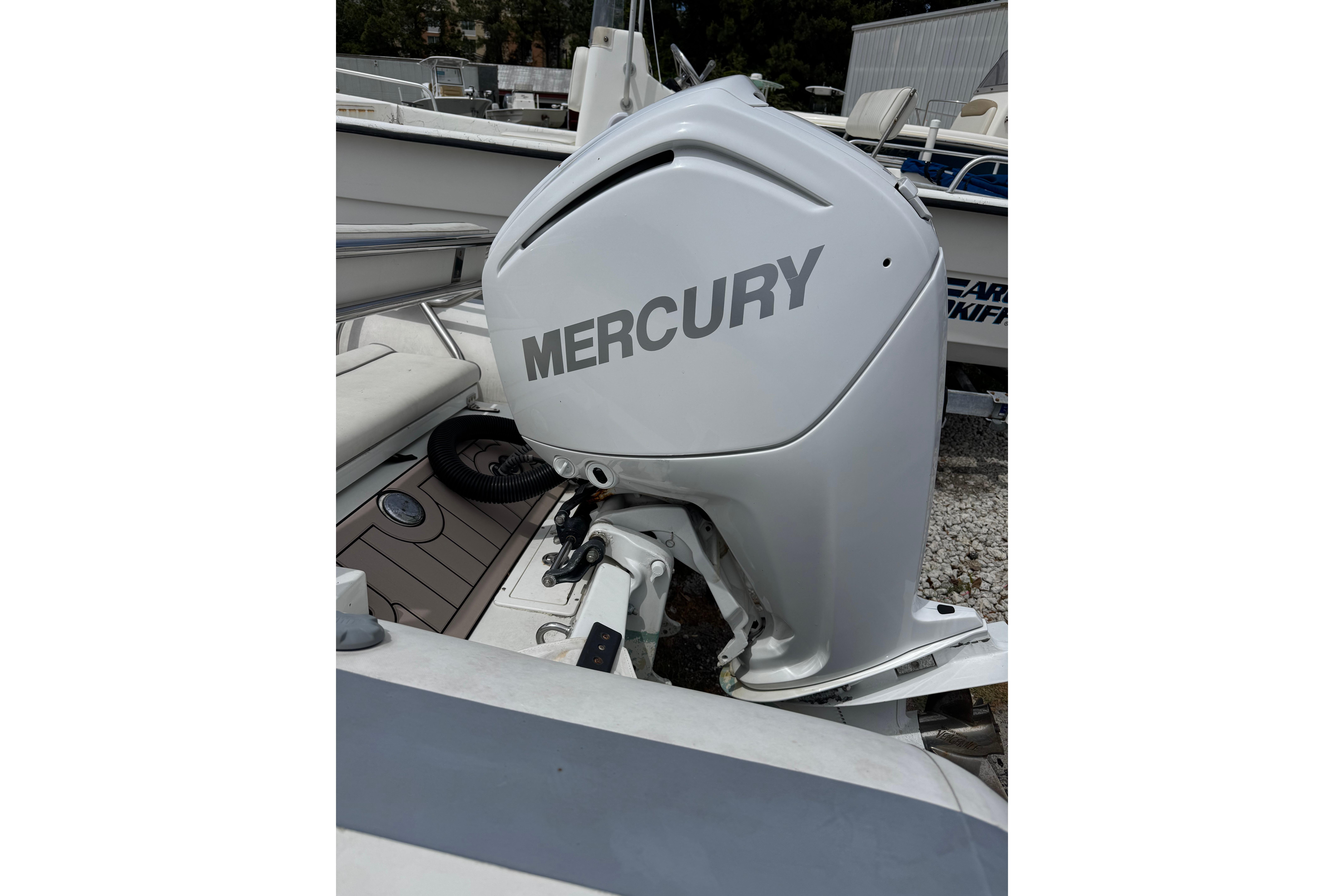 Mercury outboard motor on a 2002 Novurania 17 boat, docked outdoors.