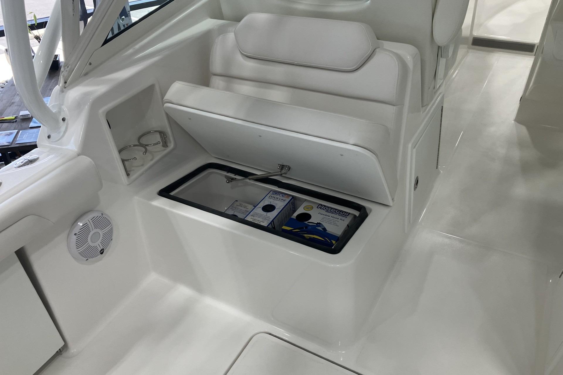 2026 Albemarle 27 Dual Console boat interior with storage compartment open.