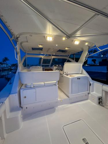 2006 Tiara Yachts 3200 Open, illuminated deck at dusk, showcasing sleek design and spacious layout.