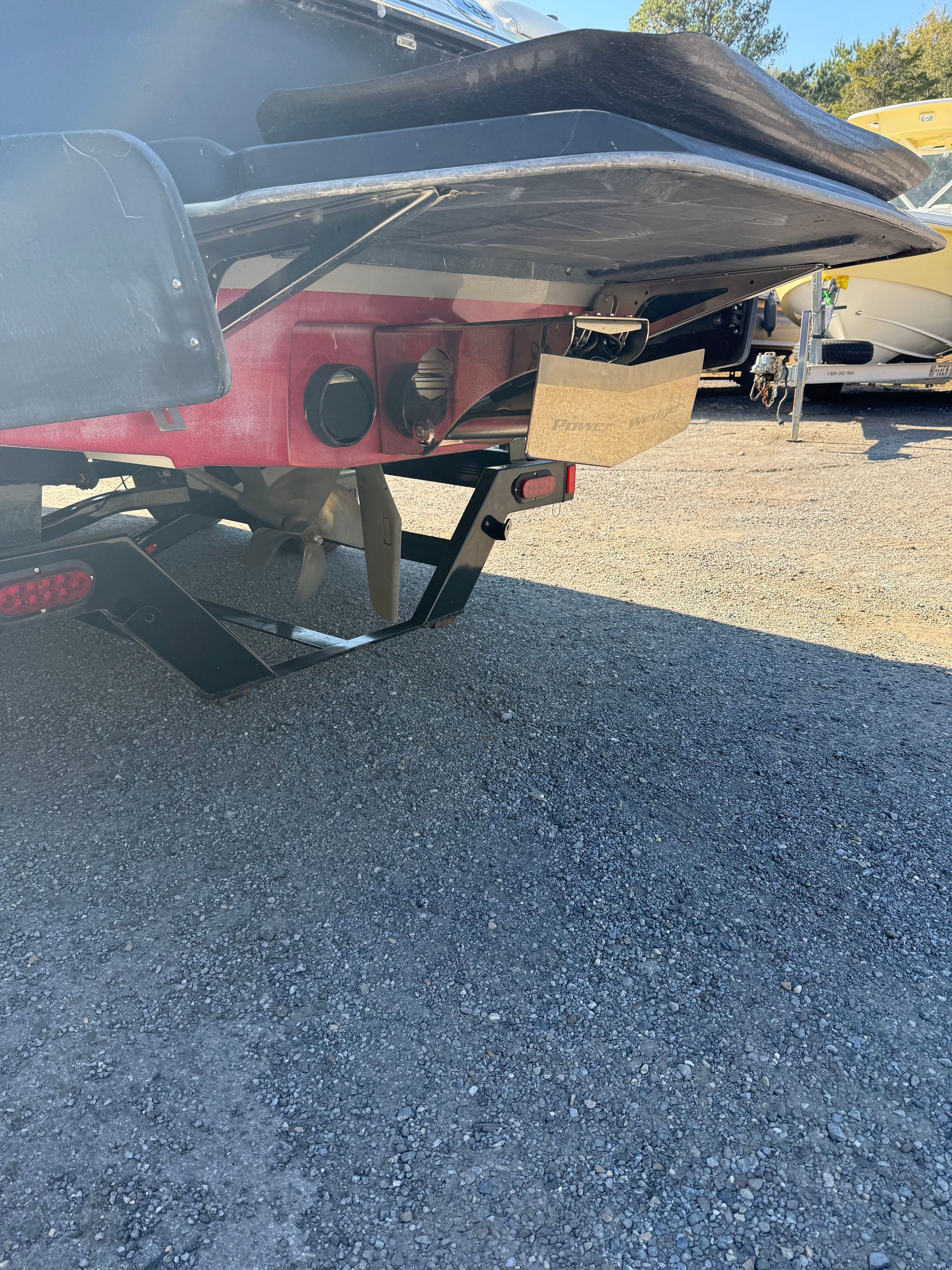 Rear view of a 2013 Malibu Wakesetter 22 MXZ on a parking lot.