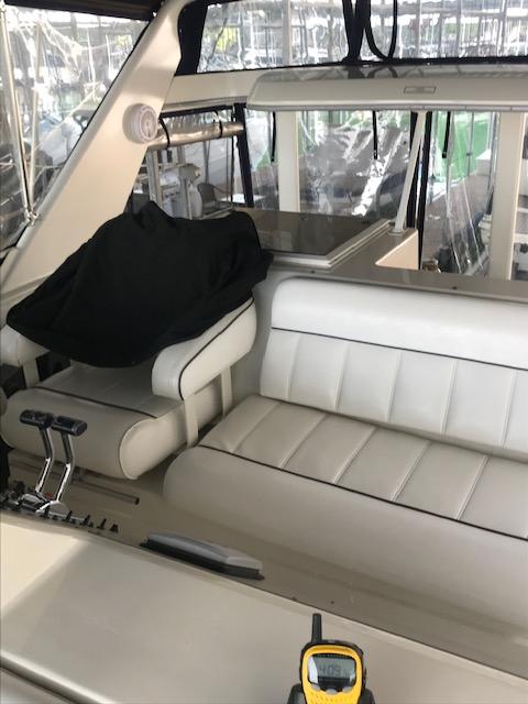 Interior of a 1996 Carver 370 yacht with white leather seating.