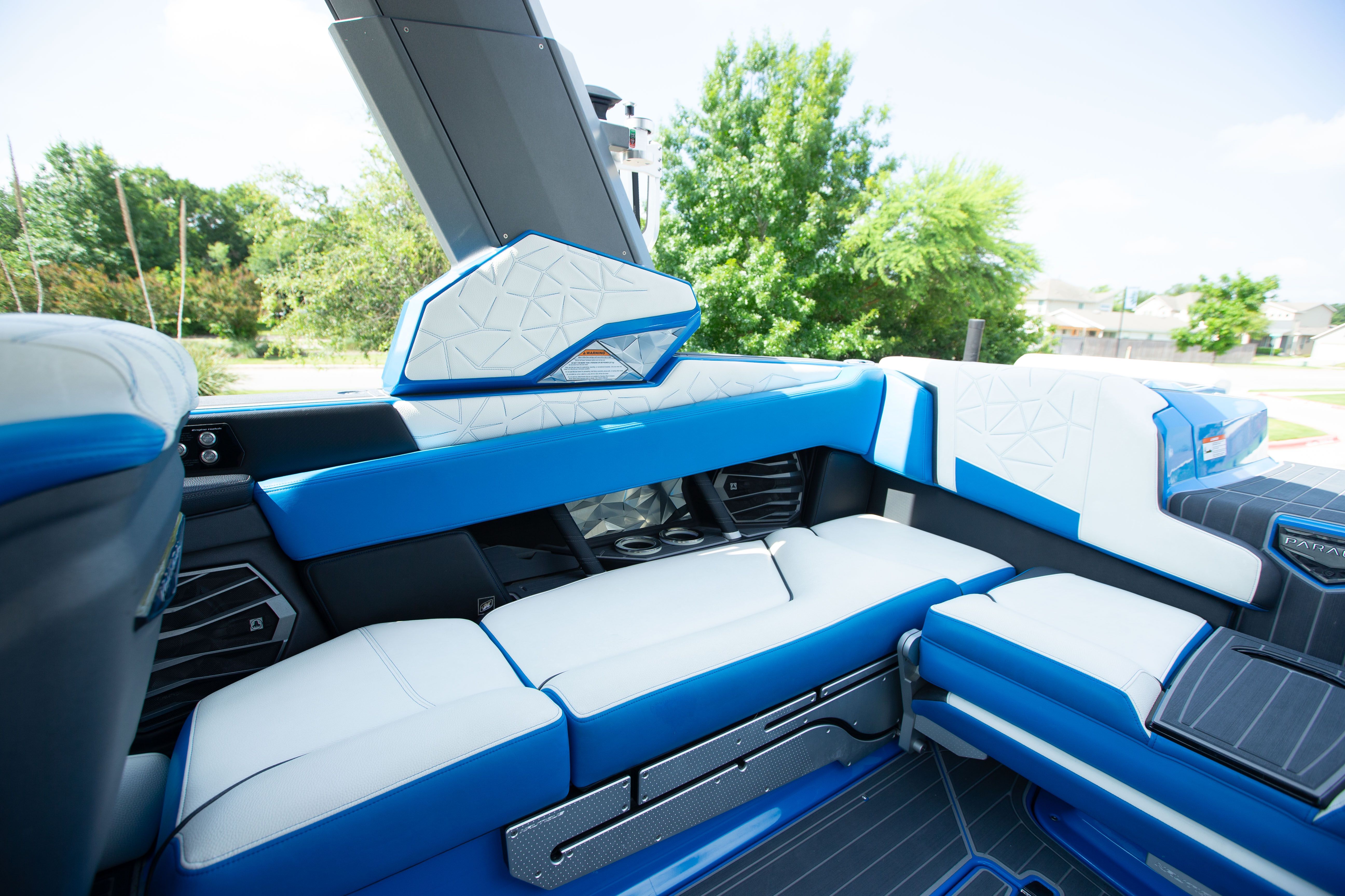 Interior of a modern boat with blue and white seating.