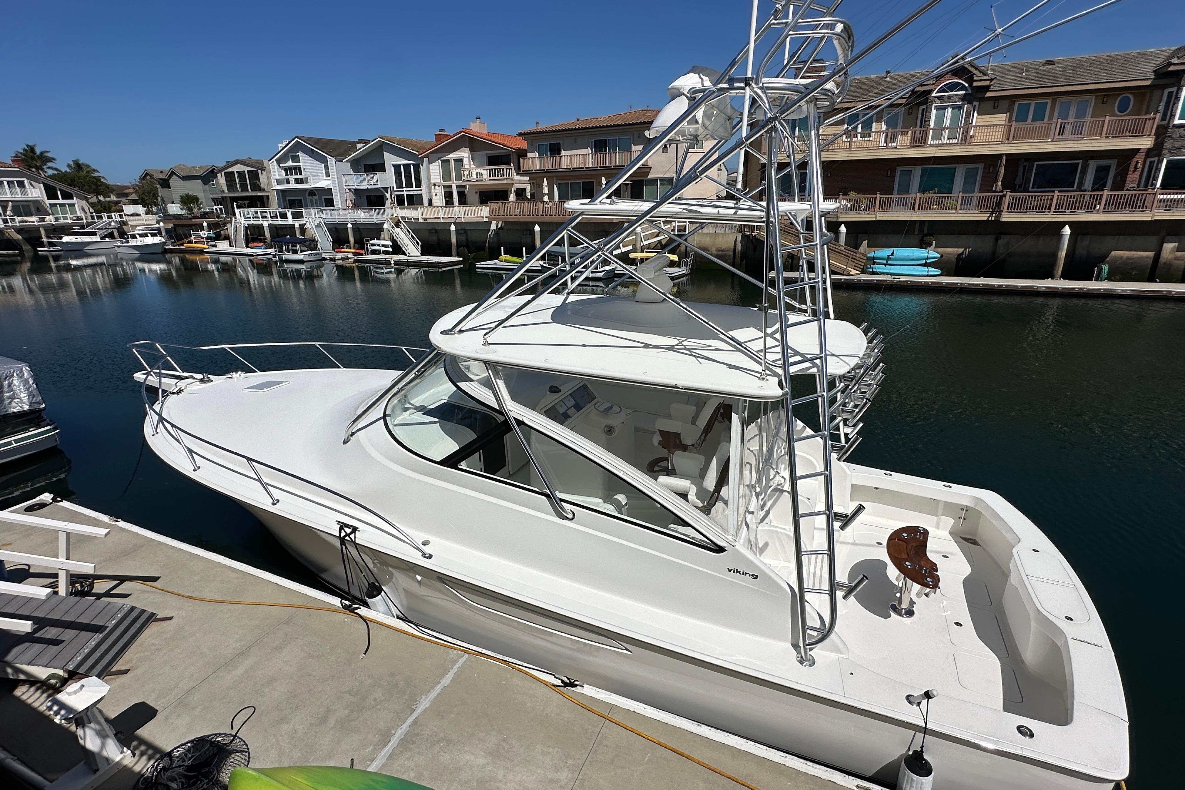 2012 Viking 42 Open yacht docked in a serene marina setting.