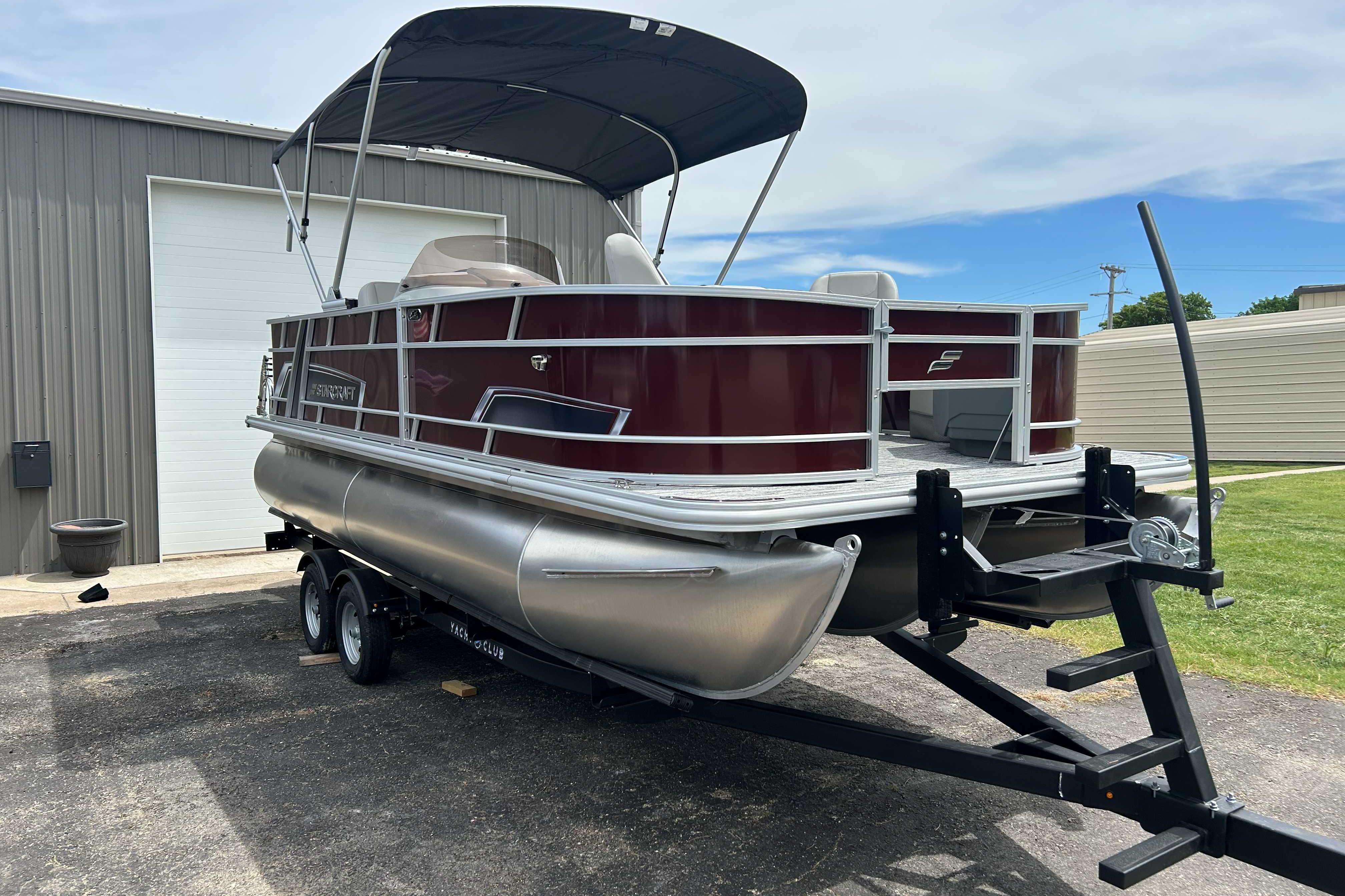 2026 Starcraft EX 20 F pontoon boat on trailer, parked outdoors.
