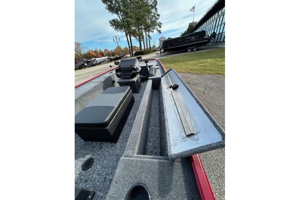 2025 Tracker Panfish 17 boat interior with open storage compartment, parked outdoors.