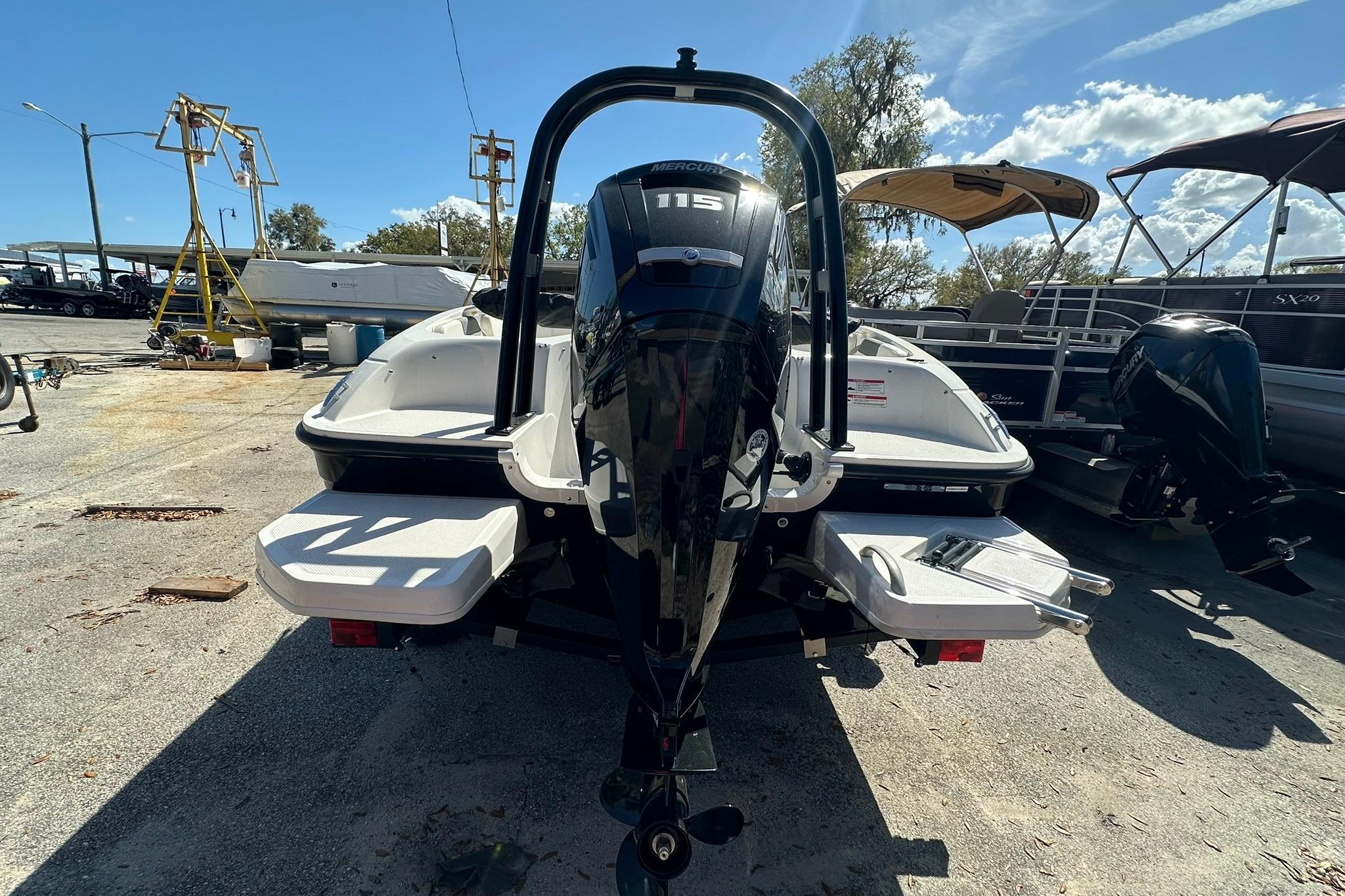 2026 Bayliner Element E18 boat with outboard motor, parked outdoors under a clear sky.