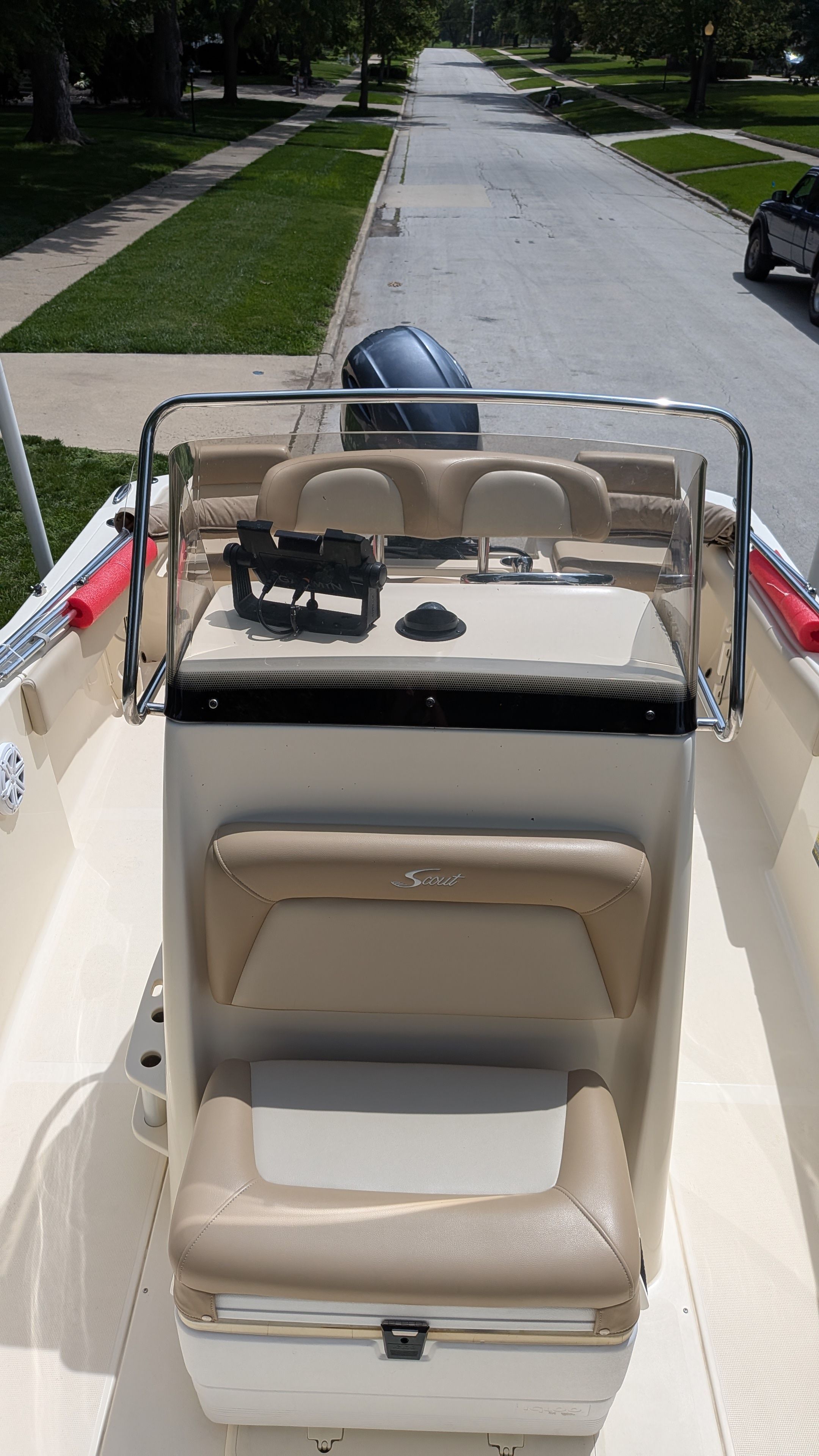 2021 Scout 195 Sportfish with beige interior, on a trailer in a residential street.