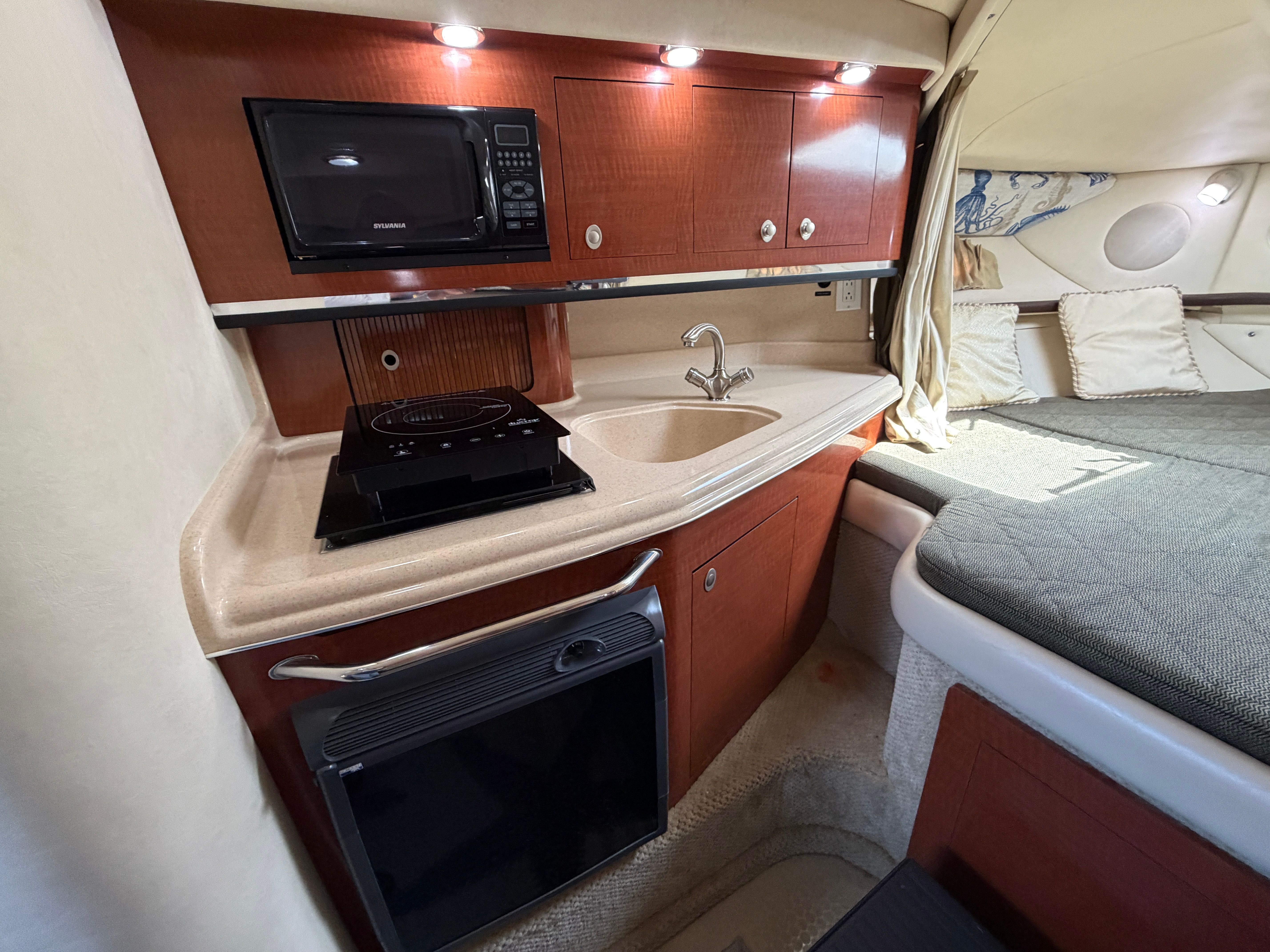 Interior of 2005 Sea Ray 290 Amberjack with kitchen and sleeping area.