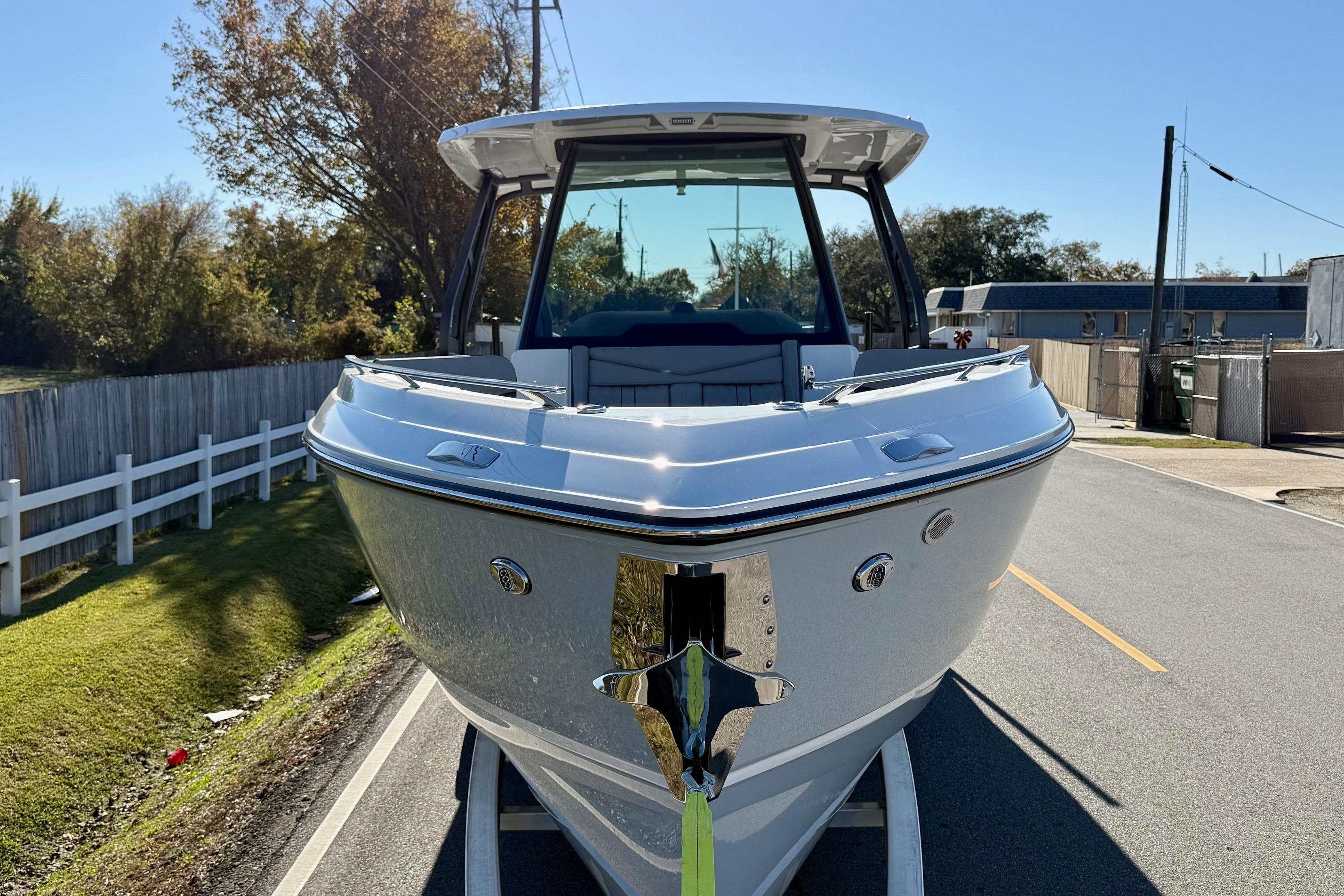 2026 Monterey Elite 30 OB boat on trailer, sunny day.