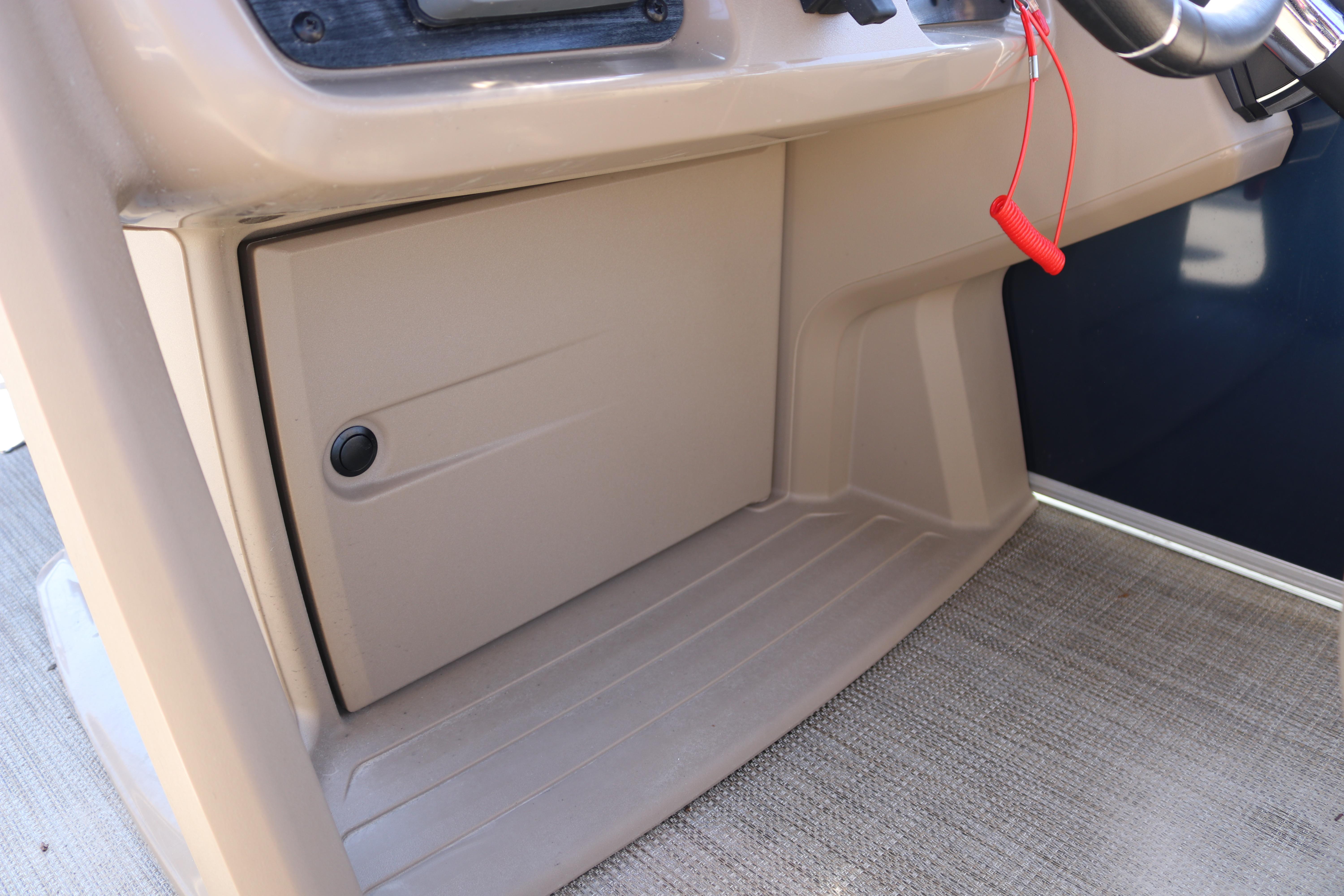 Interior view of 2025 Sun Chaser Vista Fish 18 boat console with storage compartment.