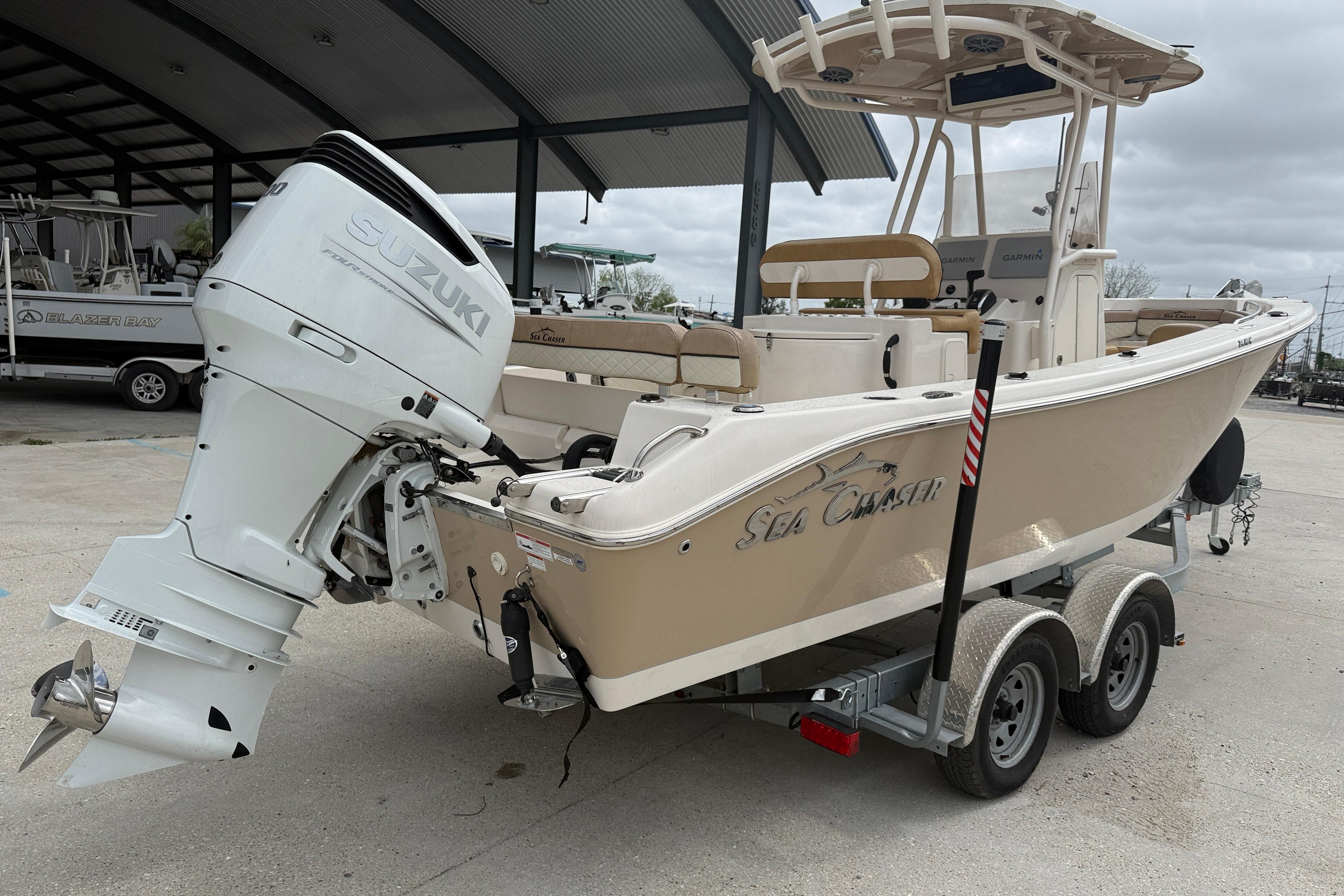 2023 SeaChaser 24 HFC boat with Suzuki outboard motor on a trailer.