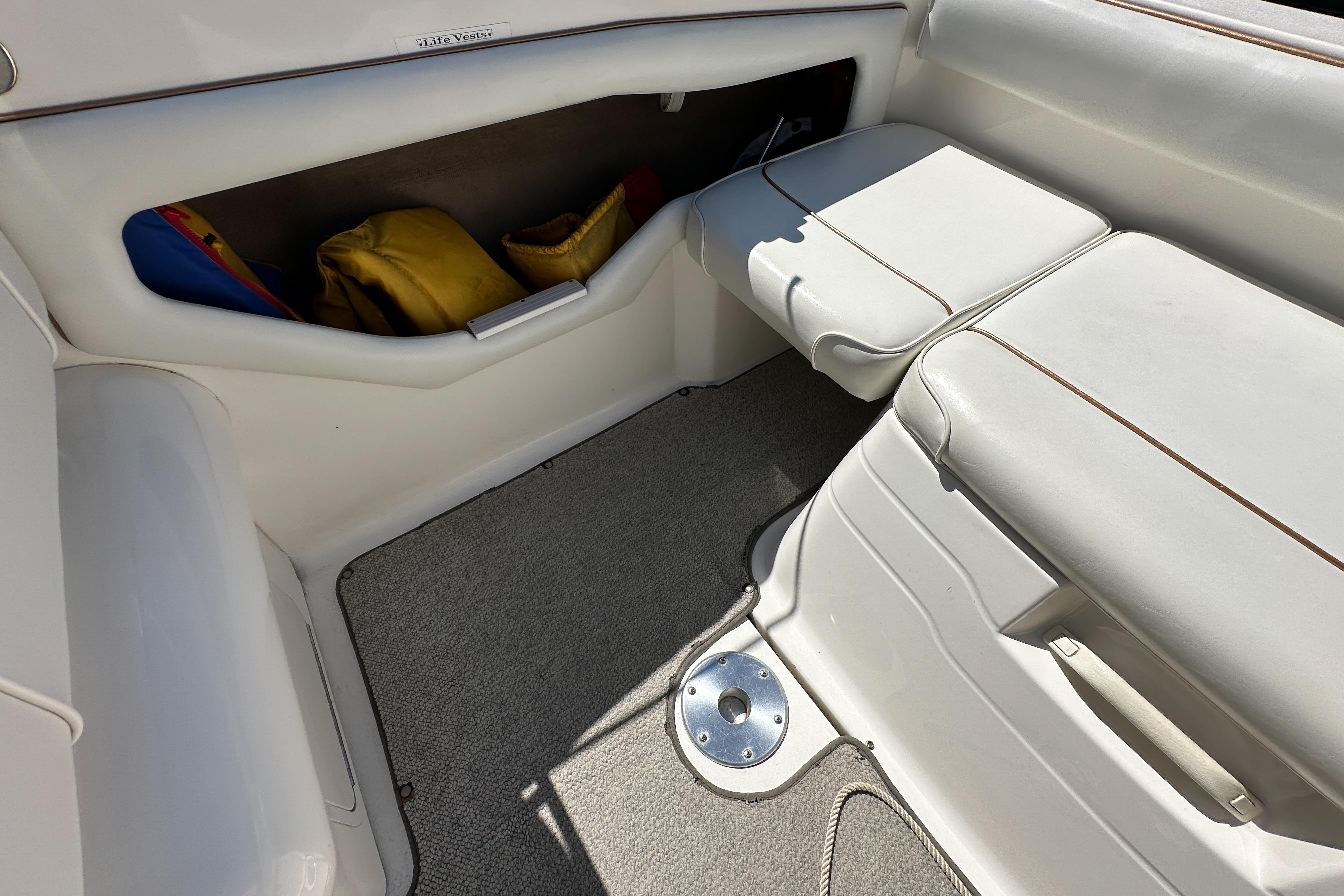 Interior of a 1998 Sea Ray 215 Express Cruiser with seating and storage.