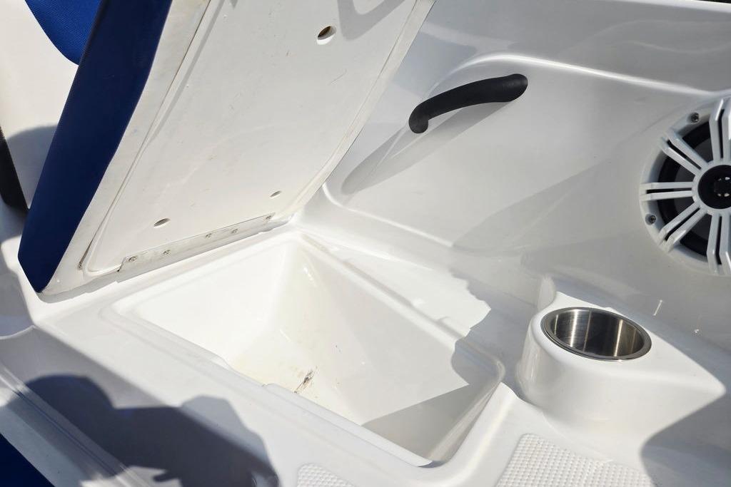 Interior of 2018 Tahoe 450 TS boat with storage compartment and speaker.