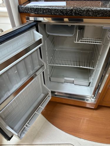 Open refrigerator in a 2006 Chaparral Signature 310 yacht.