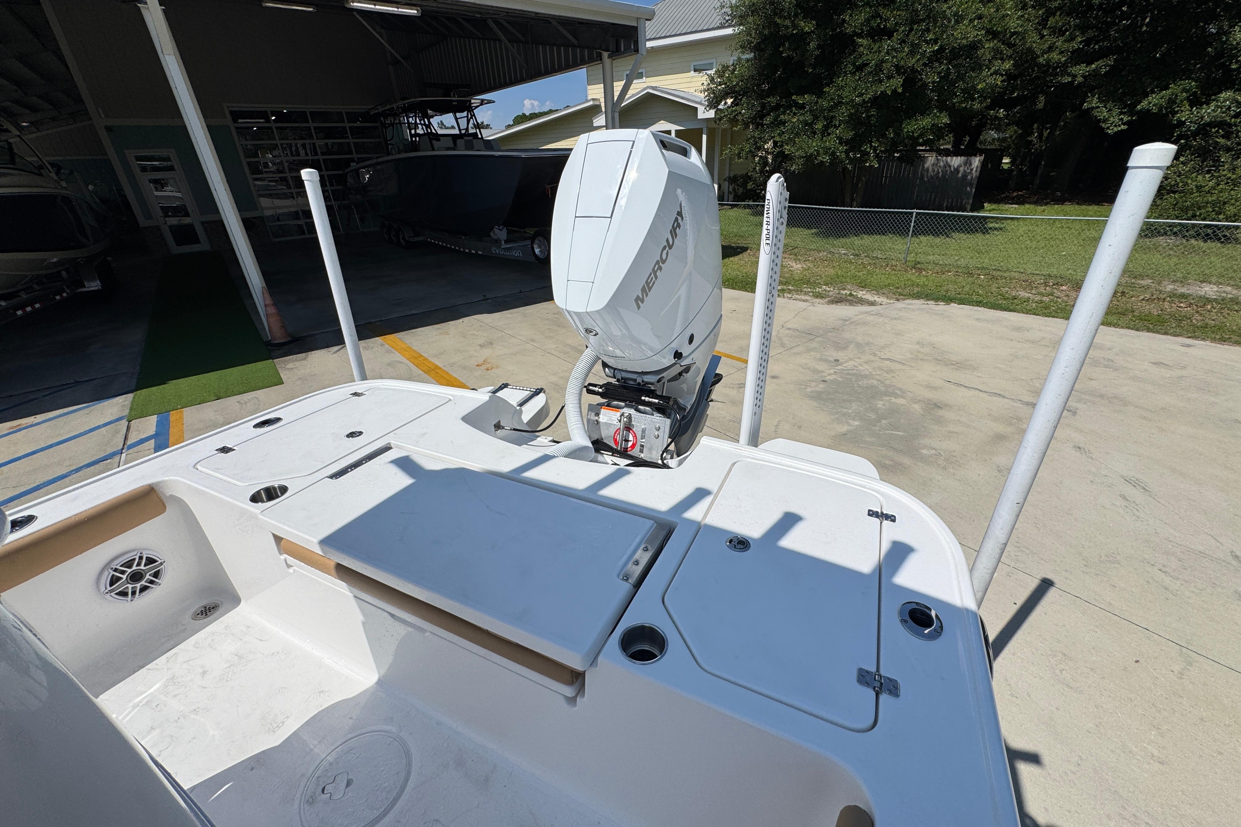 2027 Caymas 26 HB boat with Mercury outboard engine in a sunny outdoor setting.
