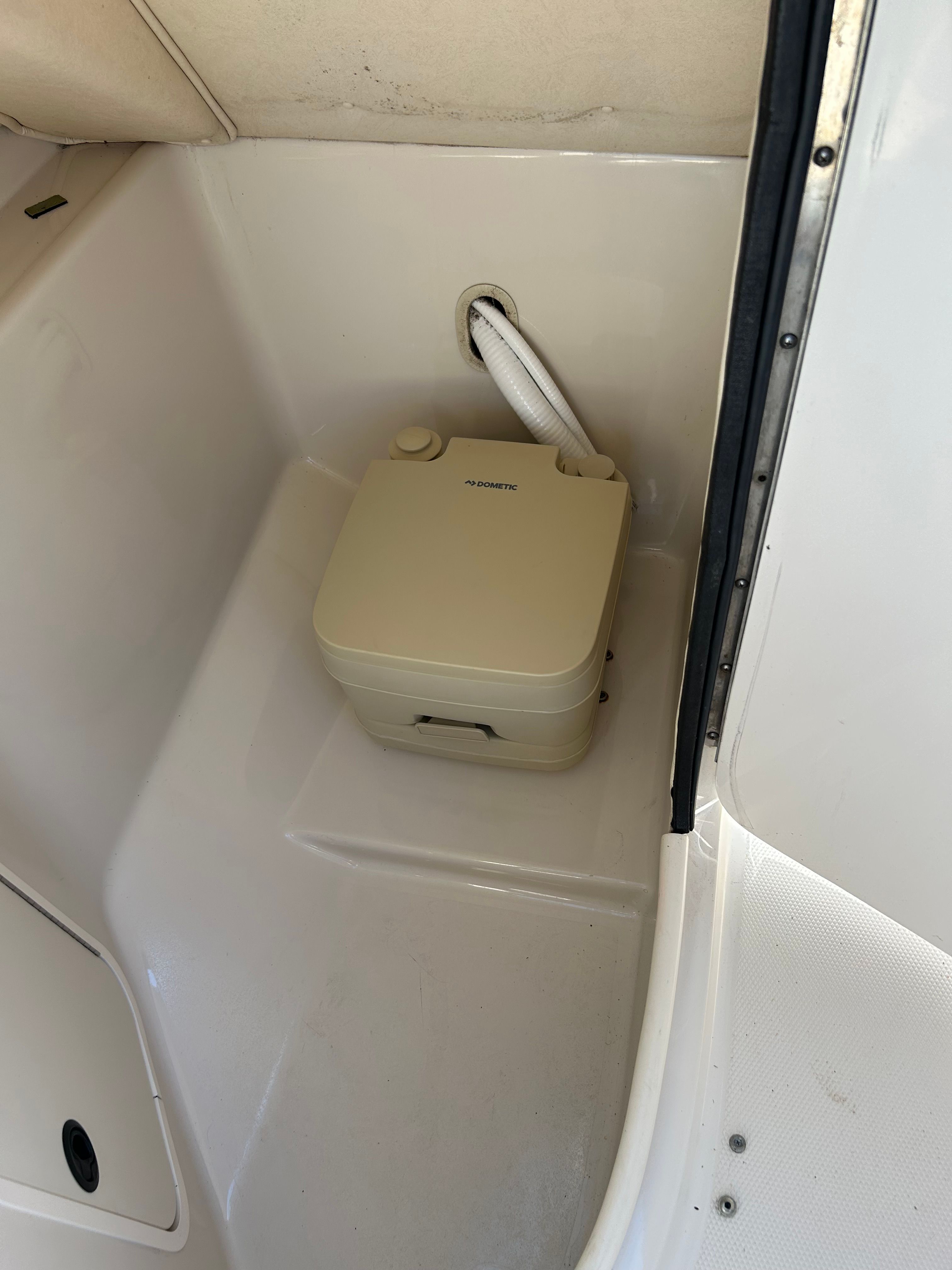 Portable toilet in a 2003 Sea Ray 240 Sundeck.