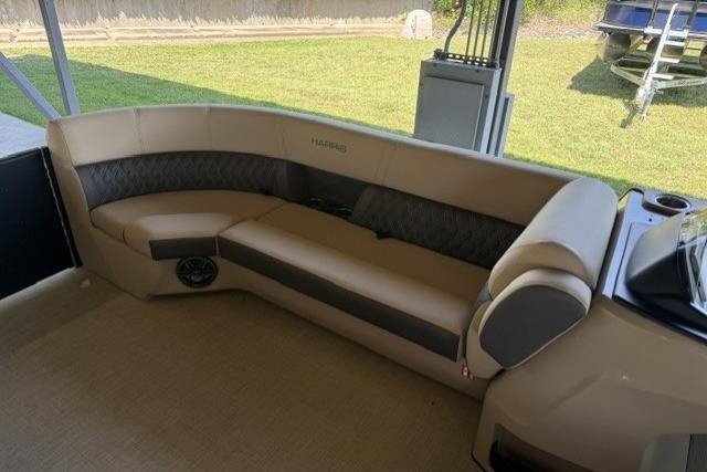 2025 Harris Sunliner 230 boat interior with beige seating and modern design.