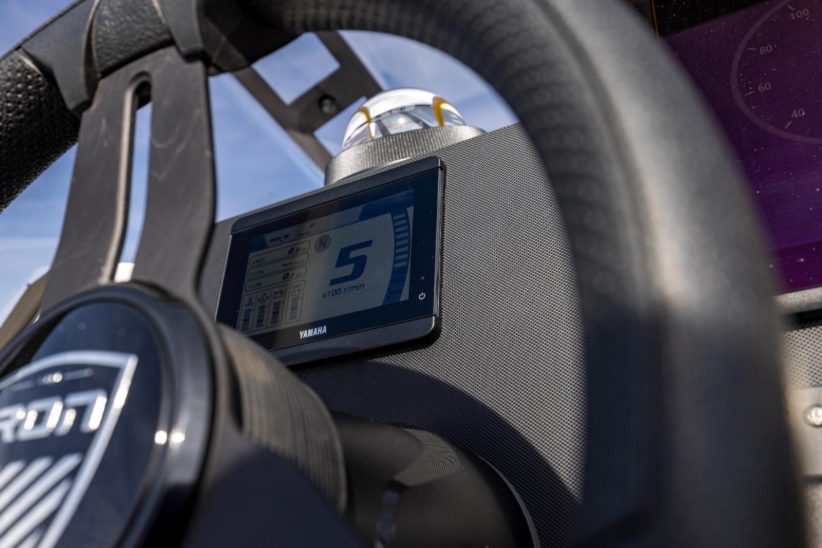 Steering wheel and digital display of 2022 Iron 707 boat, featuring Yamaha technology.