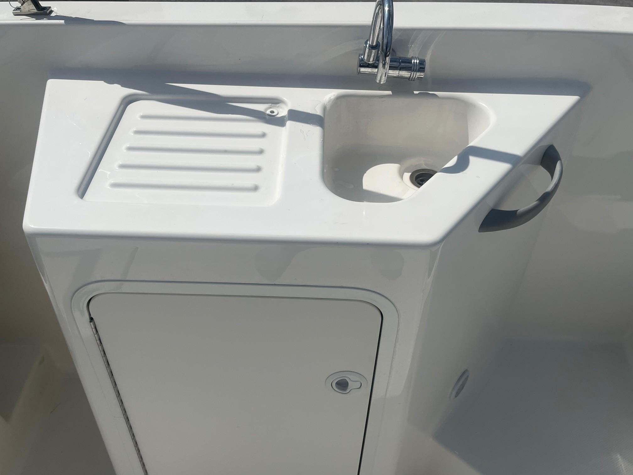 2022 Bayliner DX 2200 boat sink and storage compartment.