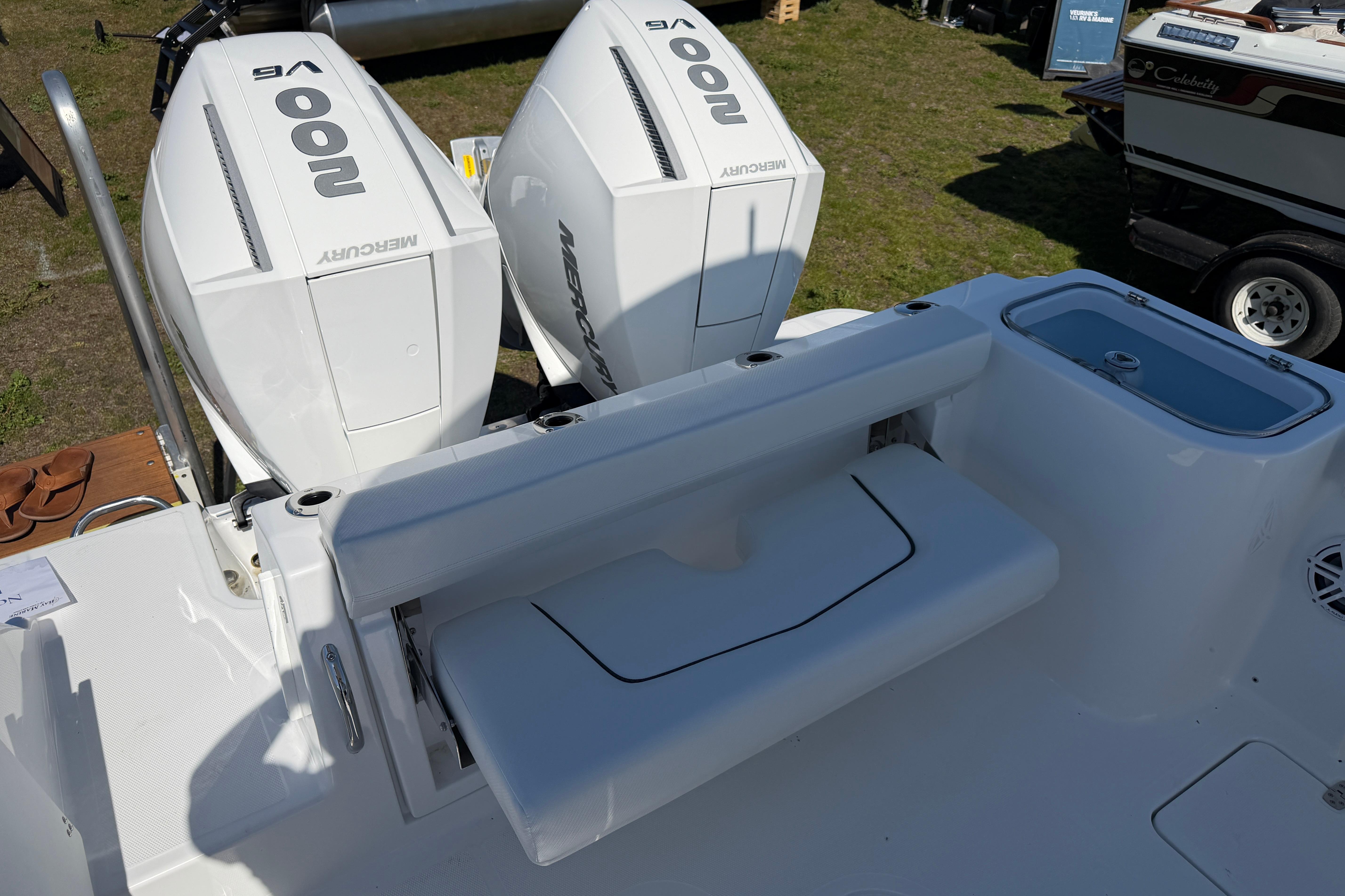 2026 Wellcraft 243 Fisherman with Mercury engines, rear seat, and livewell.