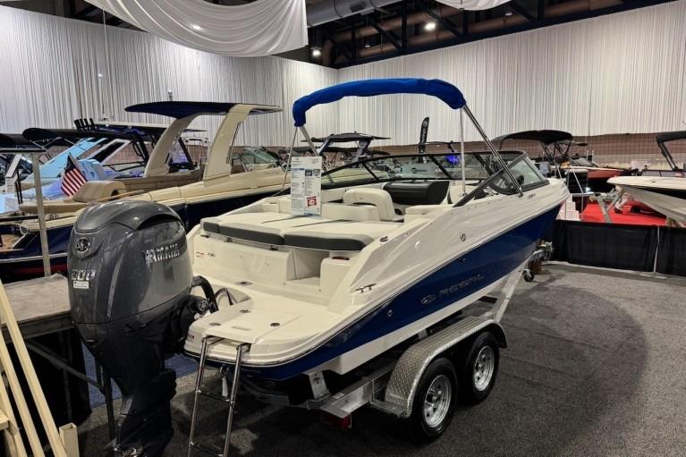 2026 Regal 21 OBX boat on display with Yamaha outboard motor.