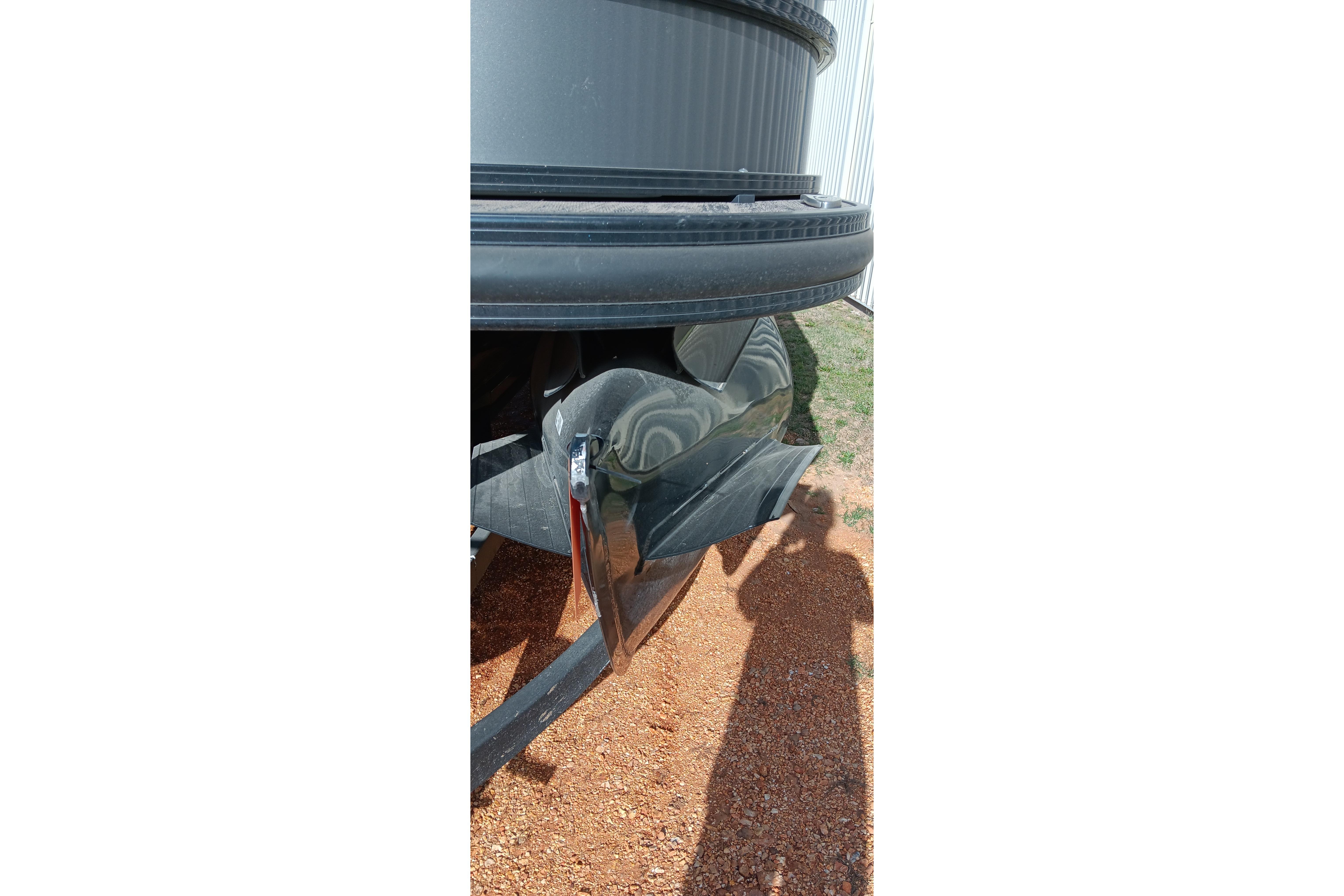 Damaged rear bumper of a 2023 Ranger 2500LS vehicle on gravel surface.
