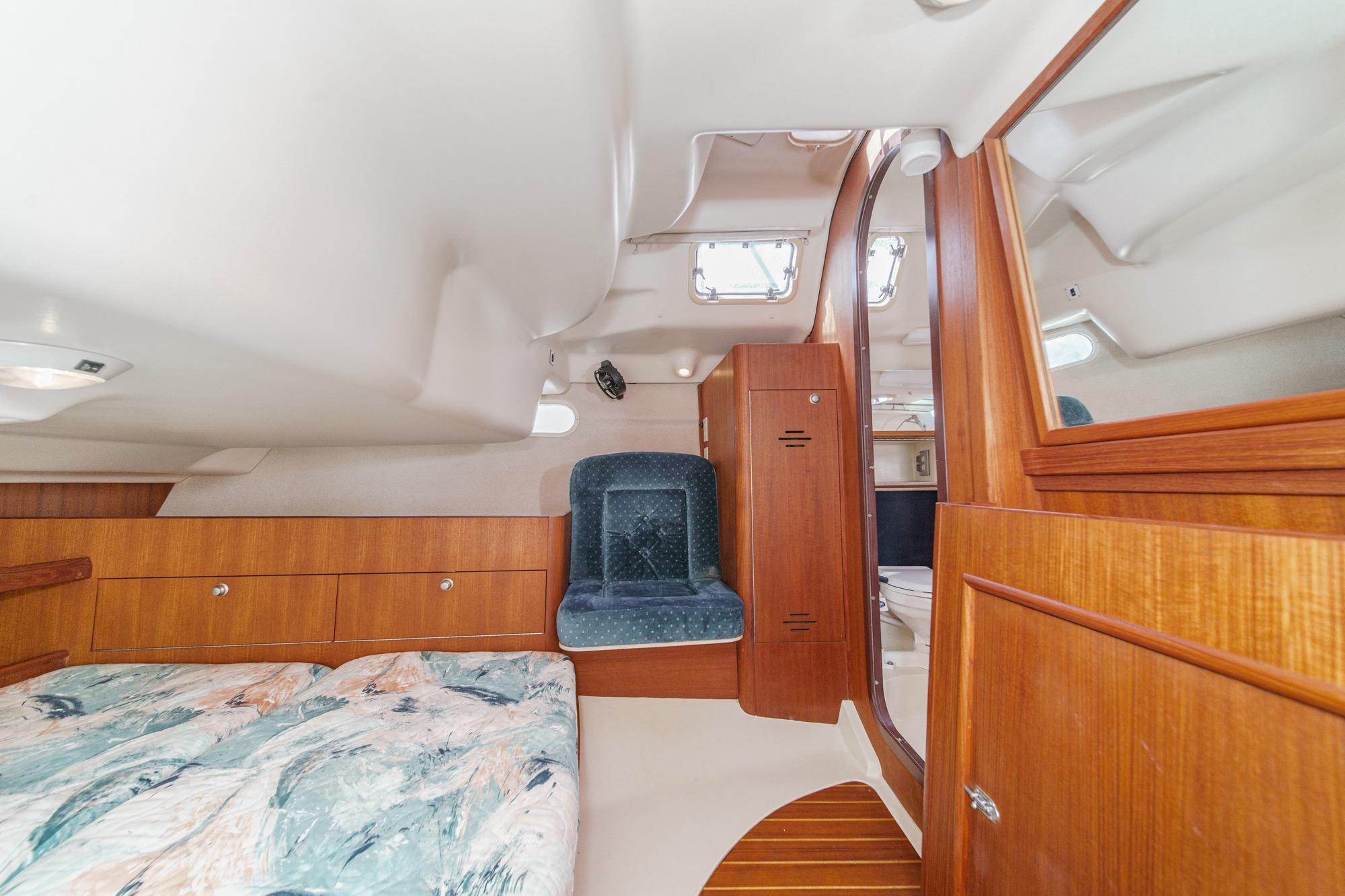 Interior of 1996 Hunter 376 sailboat with wood paneling and cozy seating area.