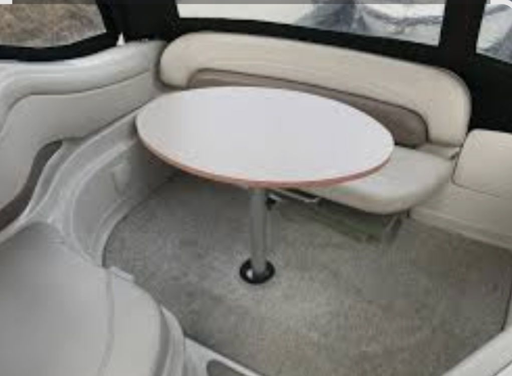 Interior of 2004 Regal Commodore 2465 boat with table and seating area.