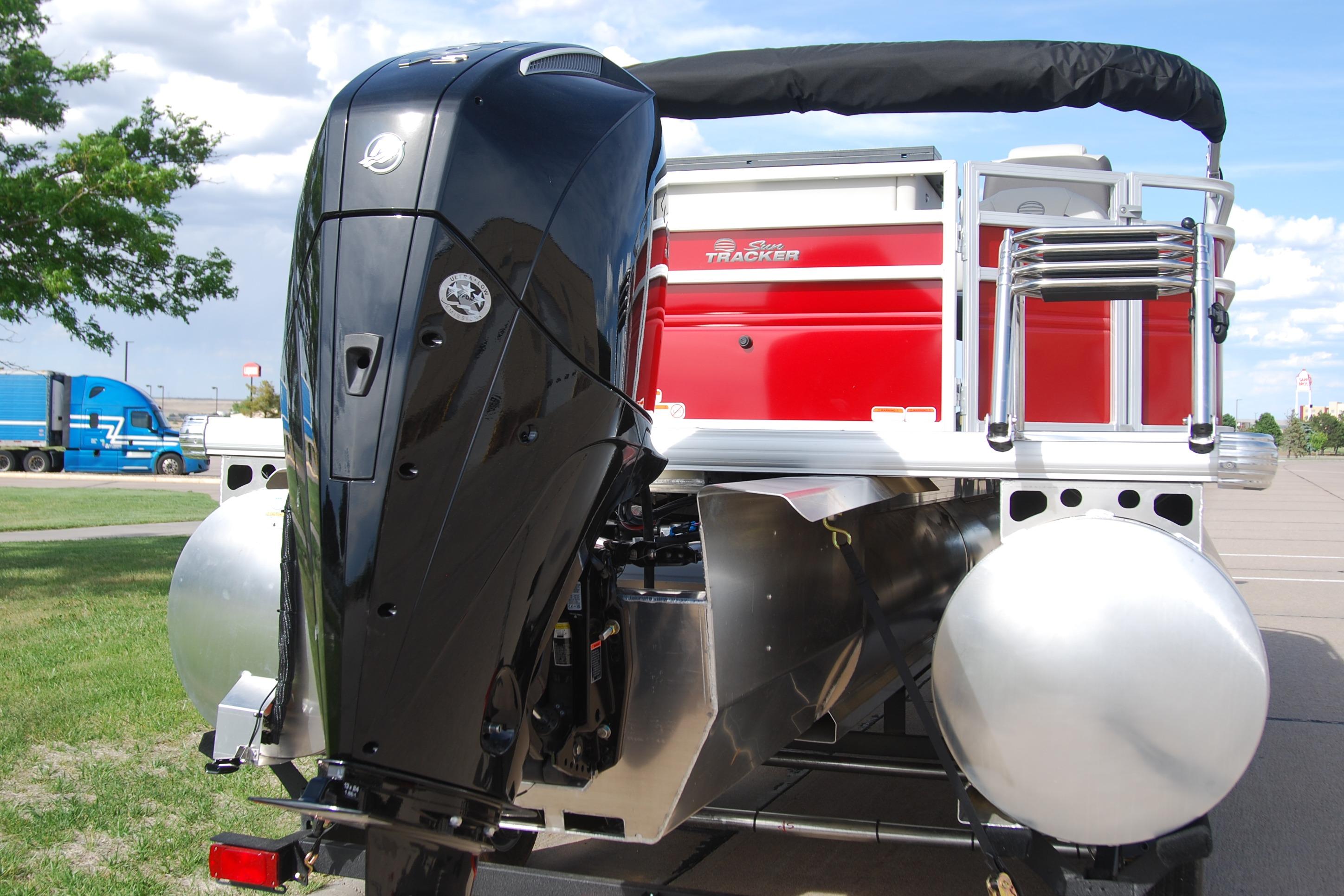 2026 Sun Tracker Fishin' Barge 22 XP3 pontoon boat with powerful outboard motor.