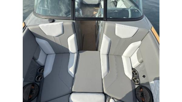 2023 MasterCraft XT22 boat interior with gray and white seating, cup holders, and sleek design.