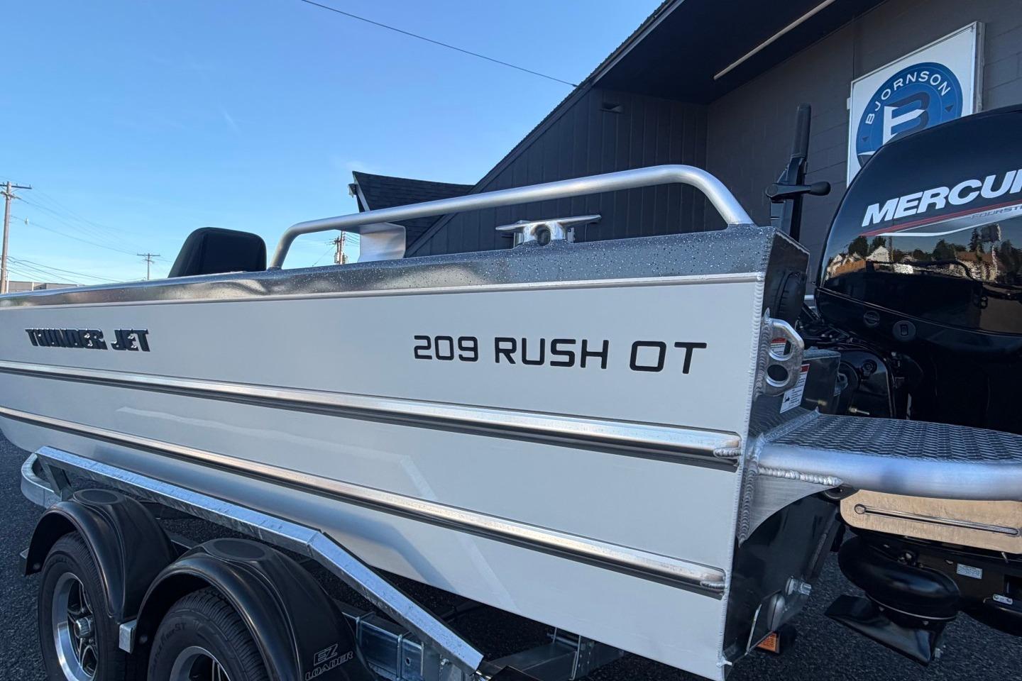 2026 Thunder Jet 209 Rush OT boat with Mercury engine, parked on a trailer.