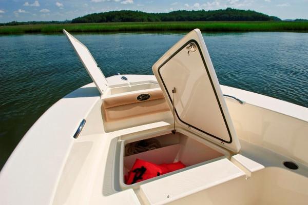 Manufacturer Provided Image: 2020 Scout 195 Sportfish boat with open storage compartments on calm water.