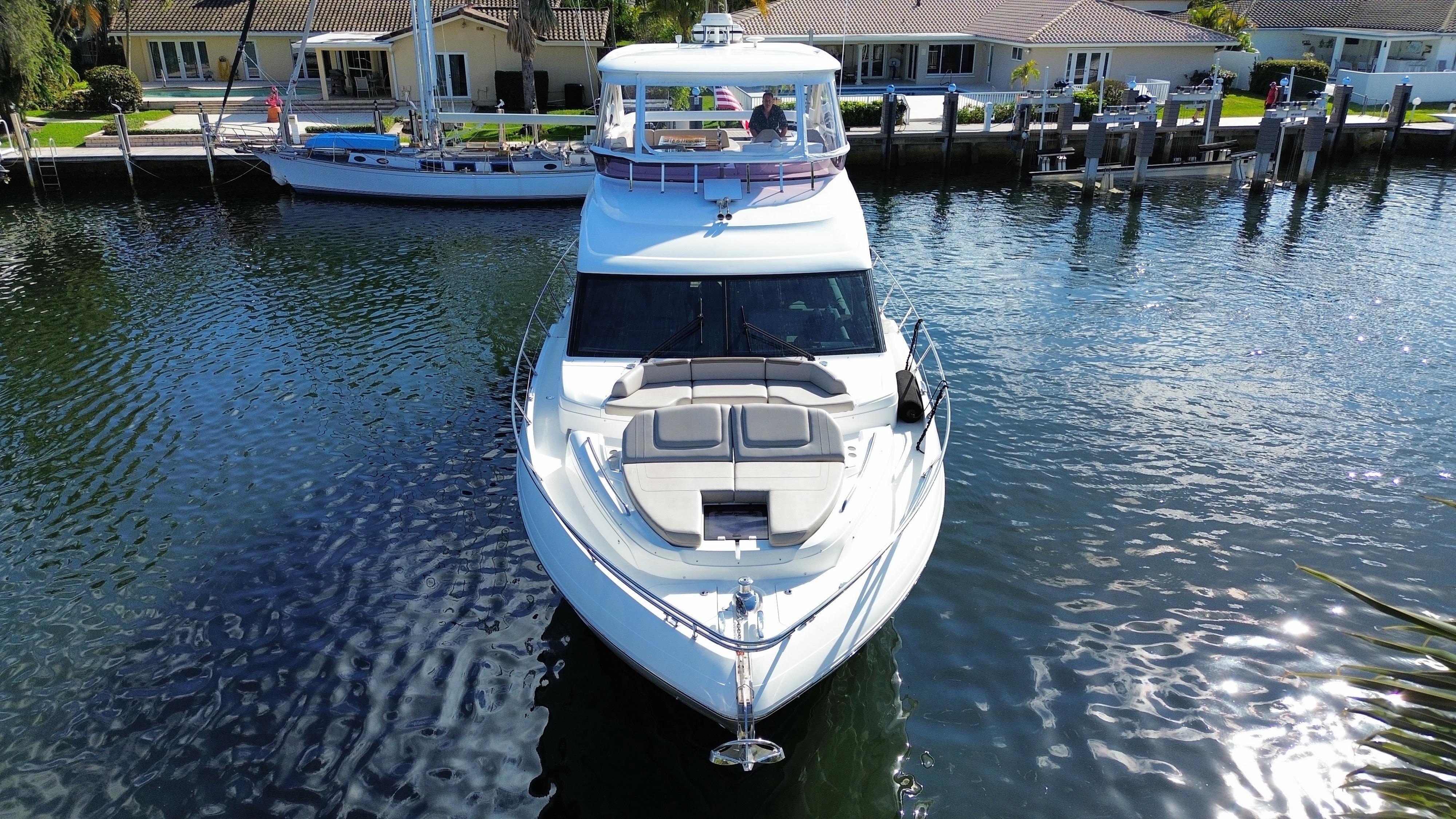 Luxury Princess F62 yacht from 2019 docked in a serene waterfront setting.
