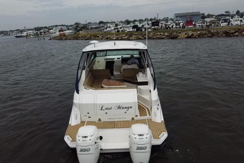2021 Sea Ray Sundancer 320 Outboard boat on water, rear view, docked at marina.