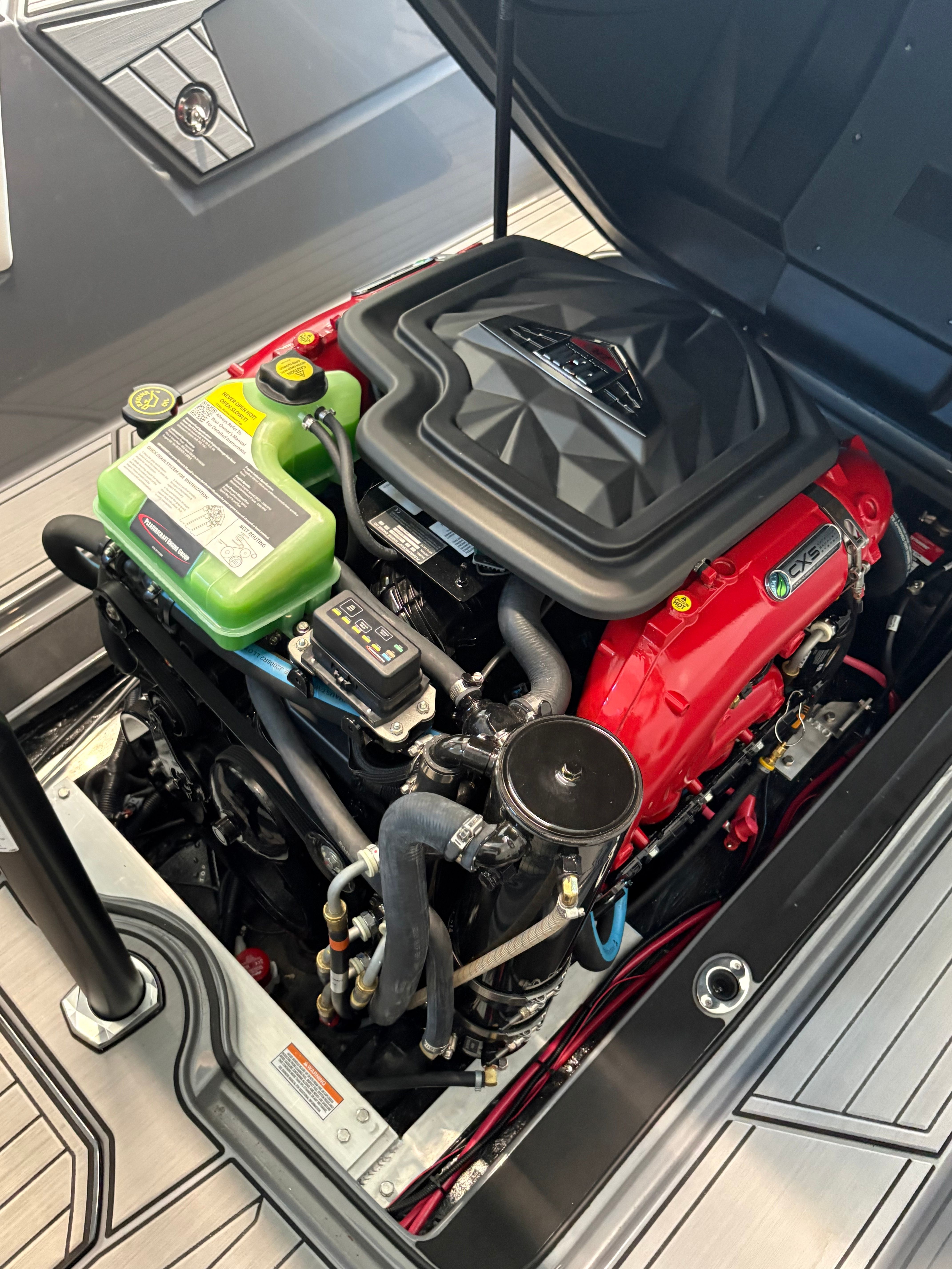 The engine compartment of a 2023 Nautique Ski Nautique featuring a powerful engine.