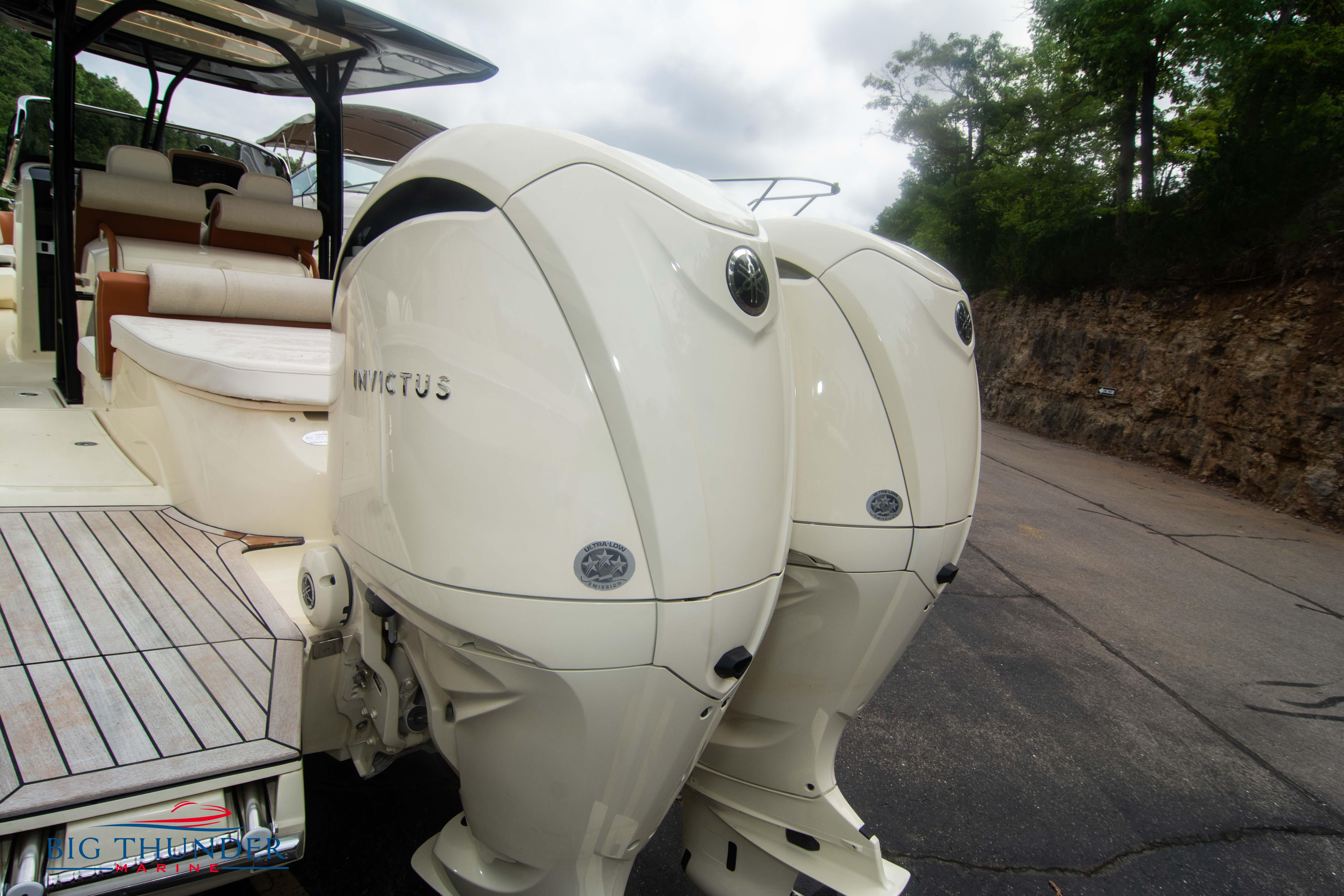 2024 Invictus TT280S boat with twin outboard engines, rear view.