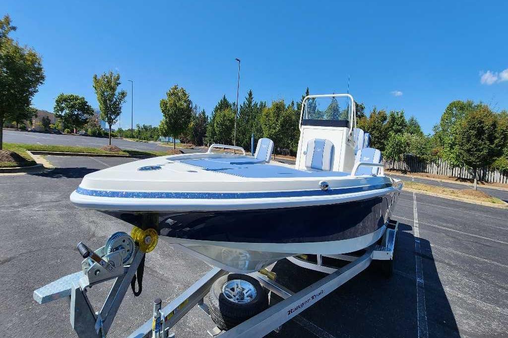 2025 Ranger 2510 Bay boat on trailer in sunny parking lot.