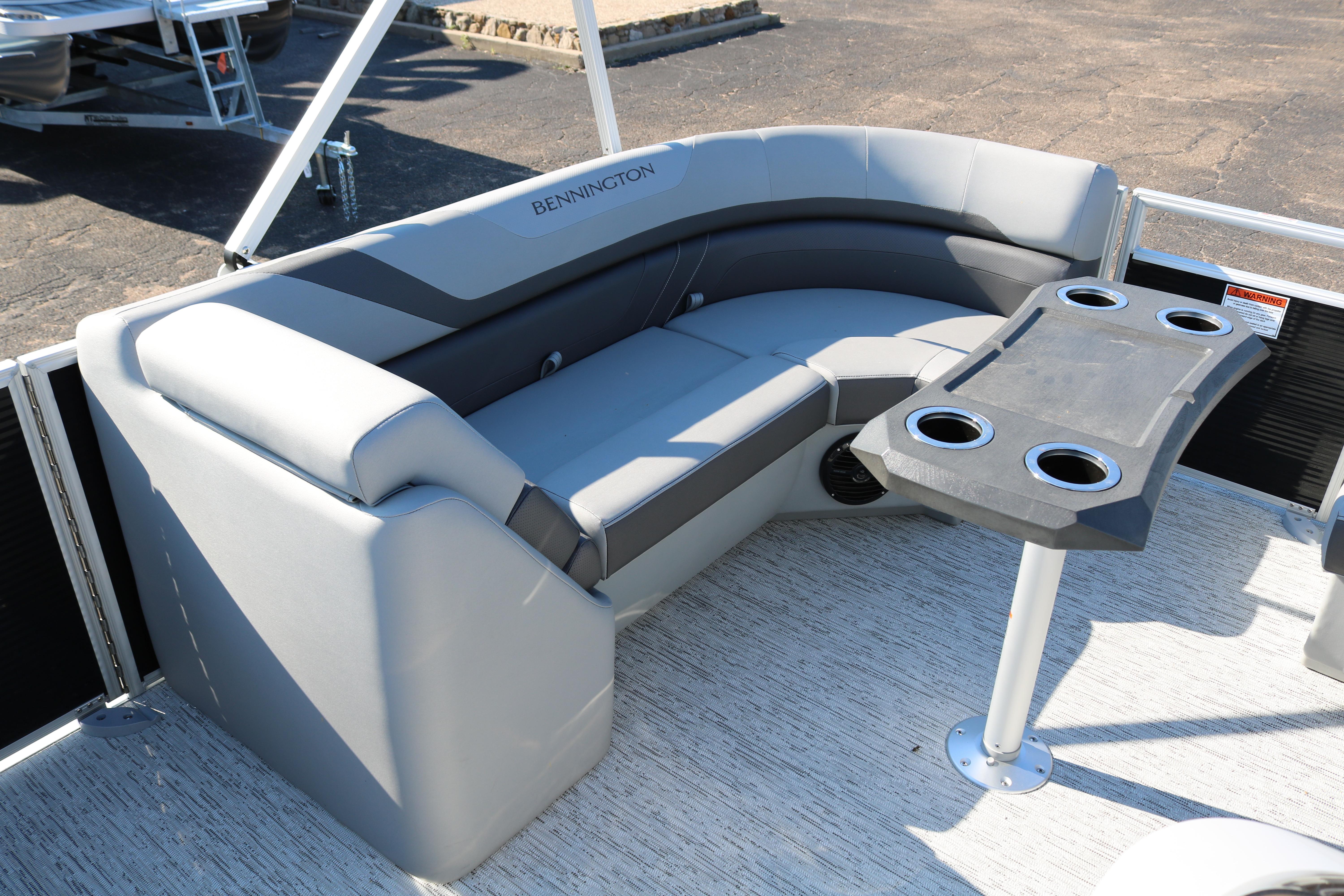 2026 Bennington 22SX Stern Radius boat with gray seating and cupholder table.